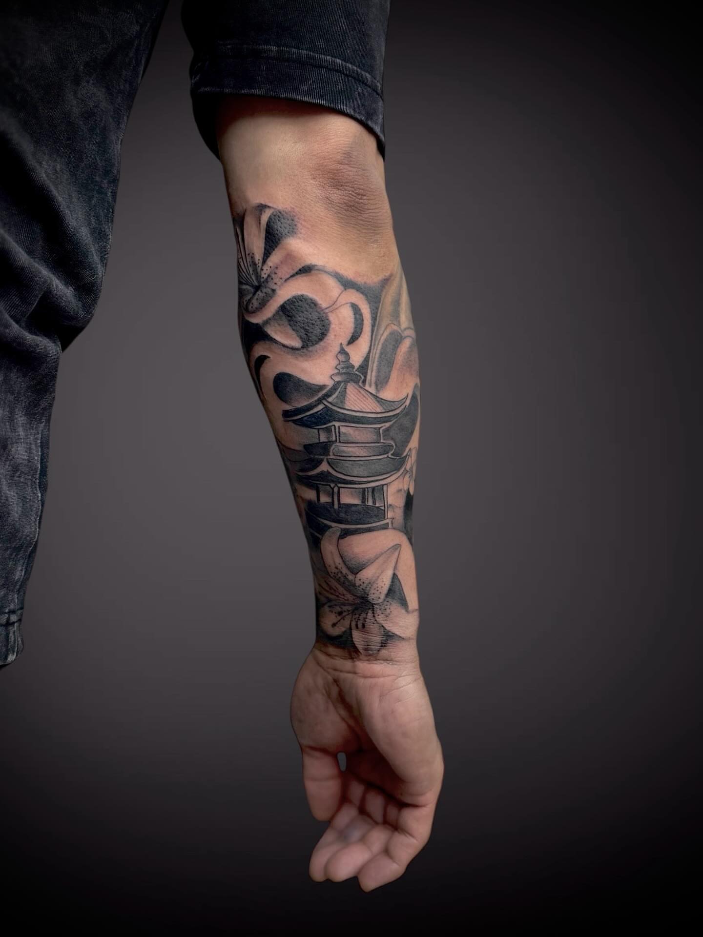 Pagoda and flowers realism tattoo on the forearm by Mitsuko Ching