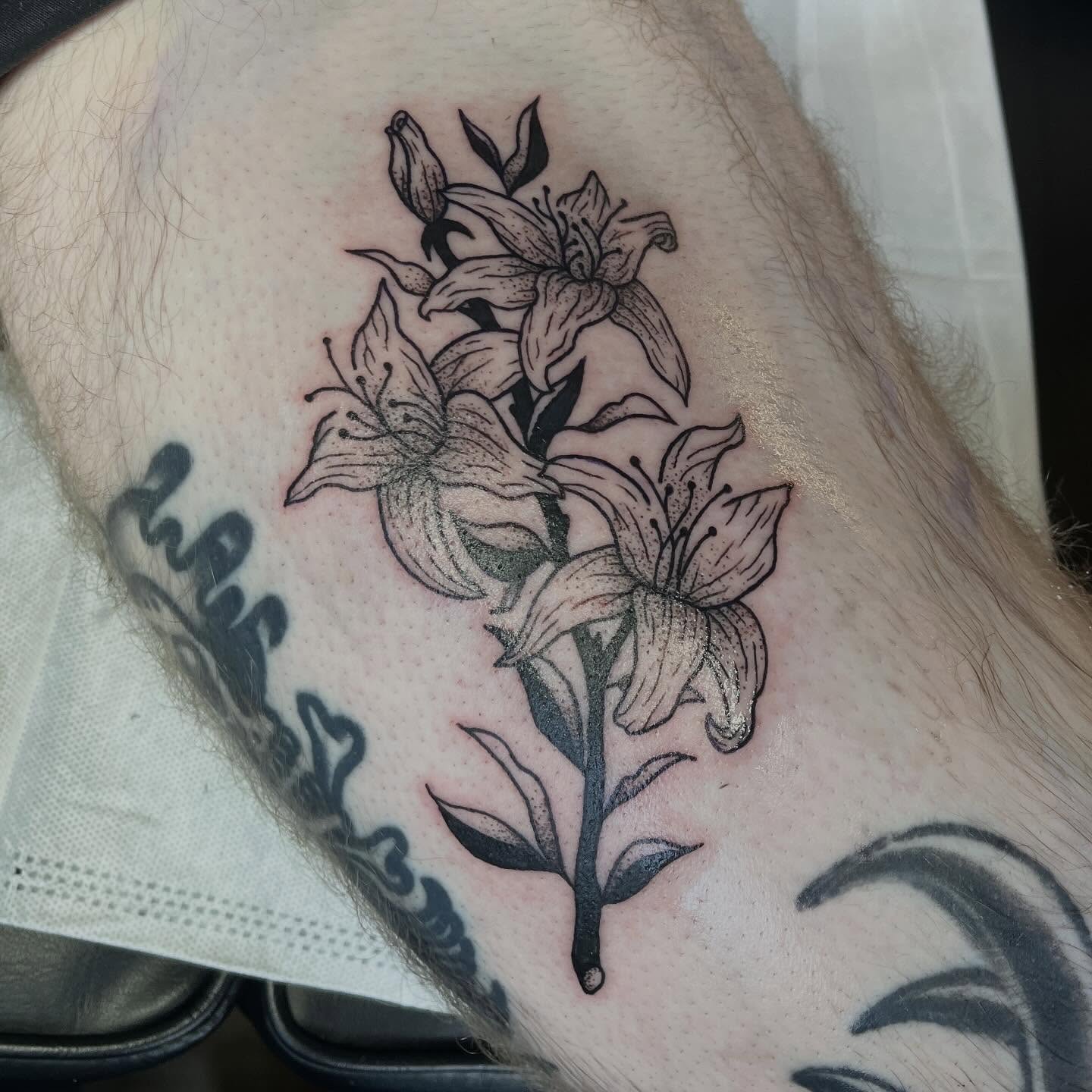 Lilies dotwork tattoo on the forearm by sarah