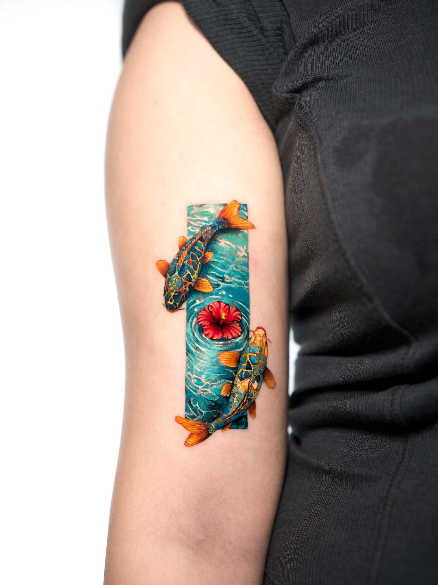 Koi fish and flower realism tattoo on the forearm by serenay akçiçek