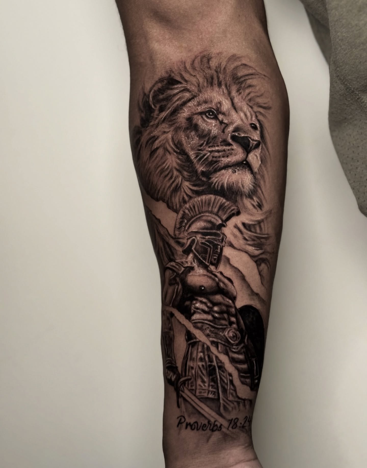 Lion and warrior realism tattoo on the forearm by Dallas Tattoo Artist