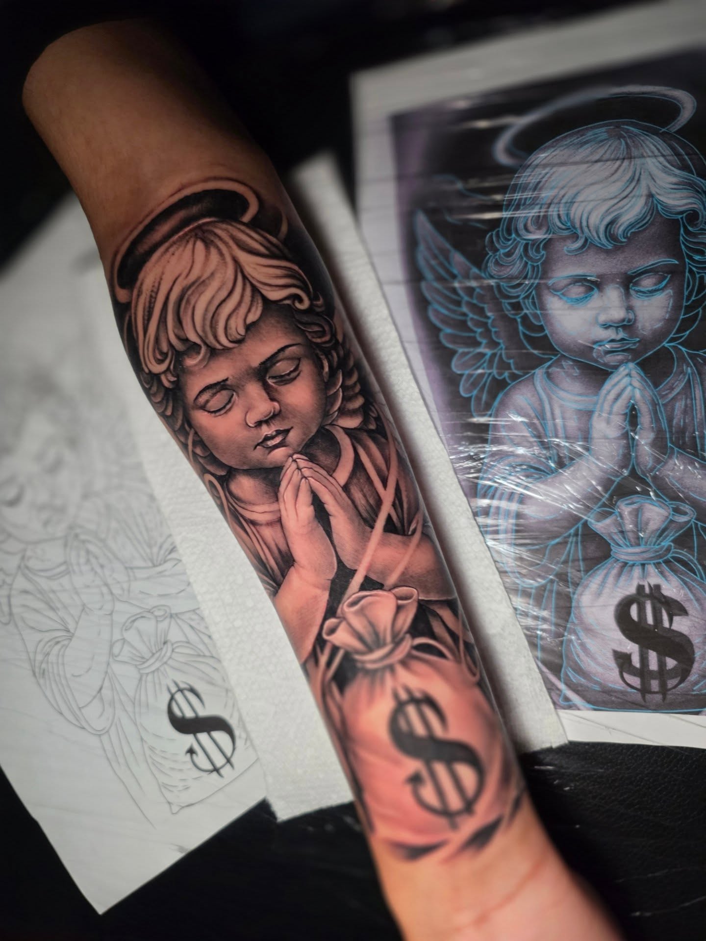 Angel praying realism tattoo on the forearm by Moose