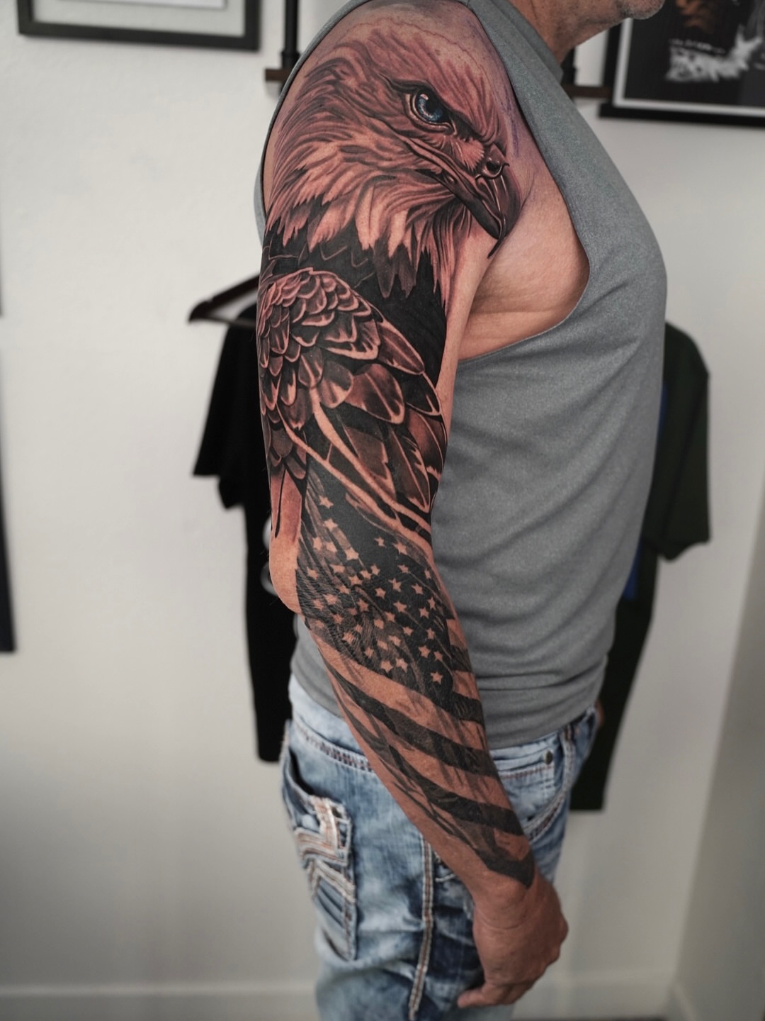 Eagle and American flag realism tattoo on the upper arm by Travis