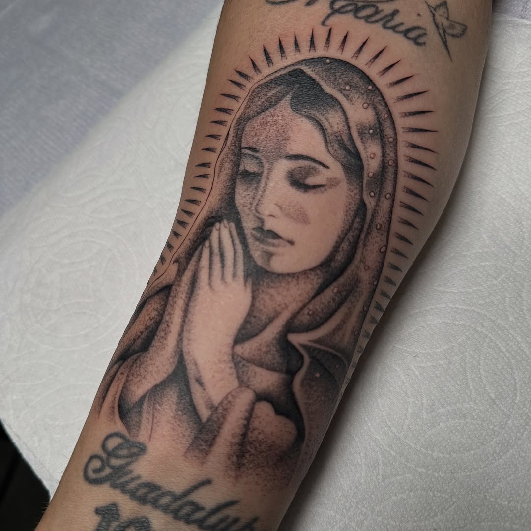 Virgin Mary praying Chicano tattoo on the forearm by christina diaz