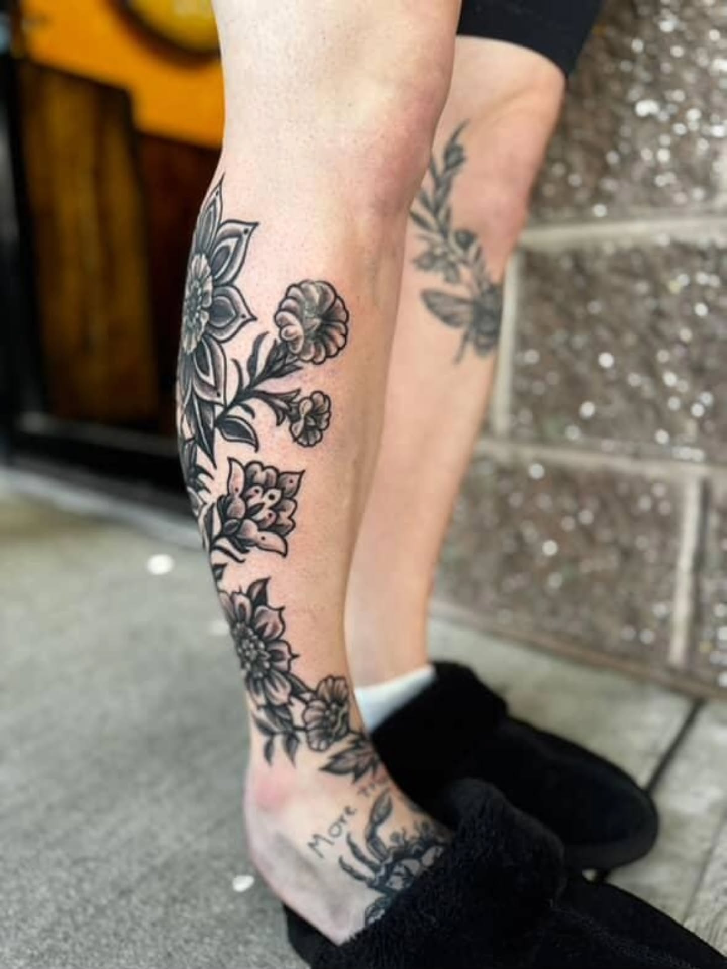 Floral design black and grey tattoo on the calf by Jennalea