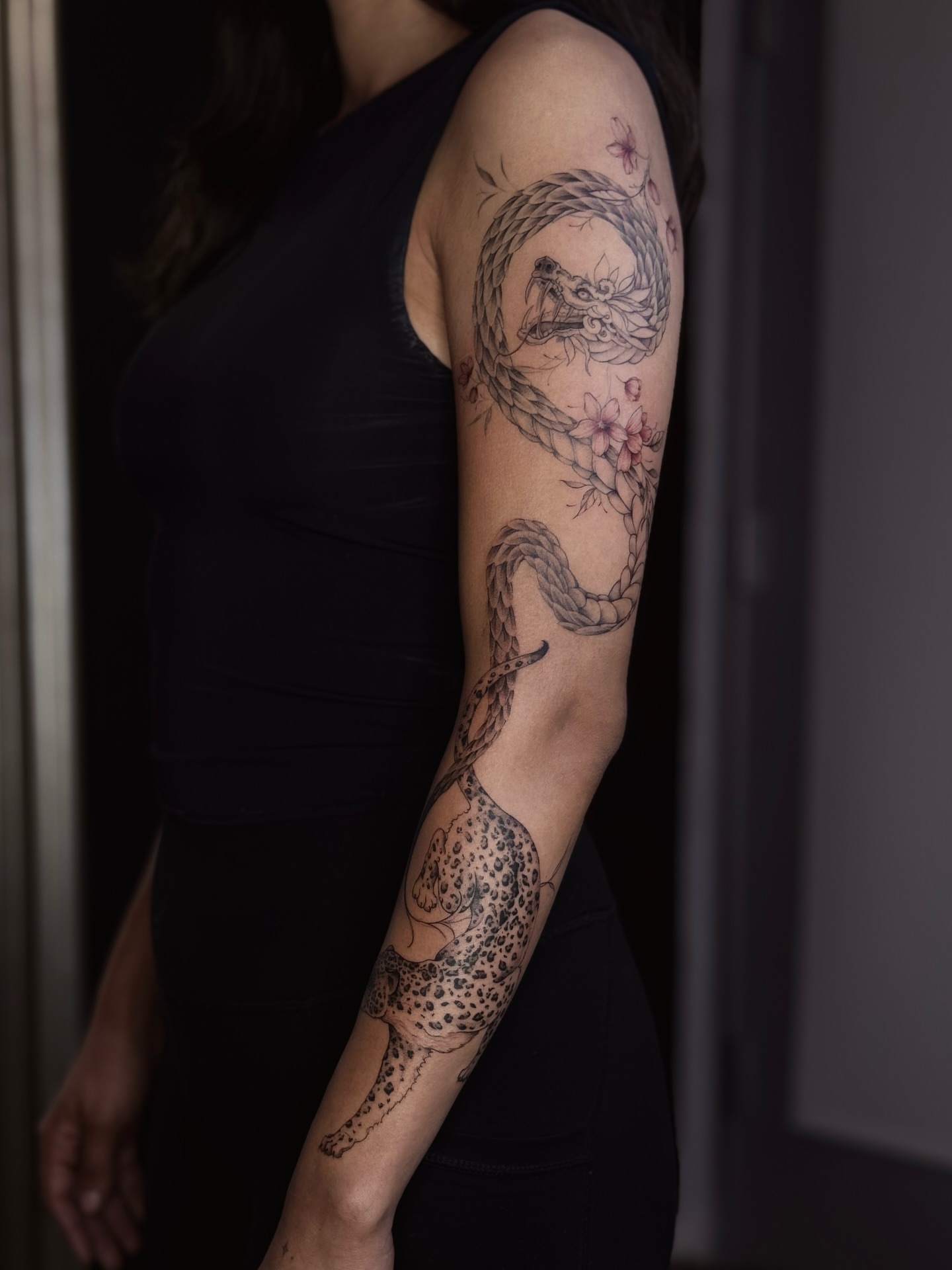 Dragon and flowers dotwork tattoo on the forearm by Daria