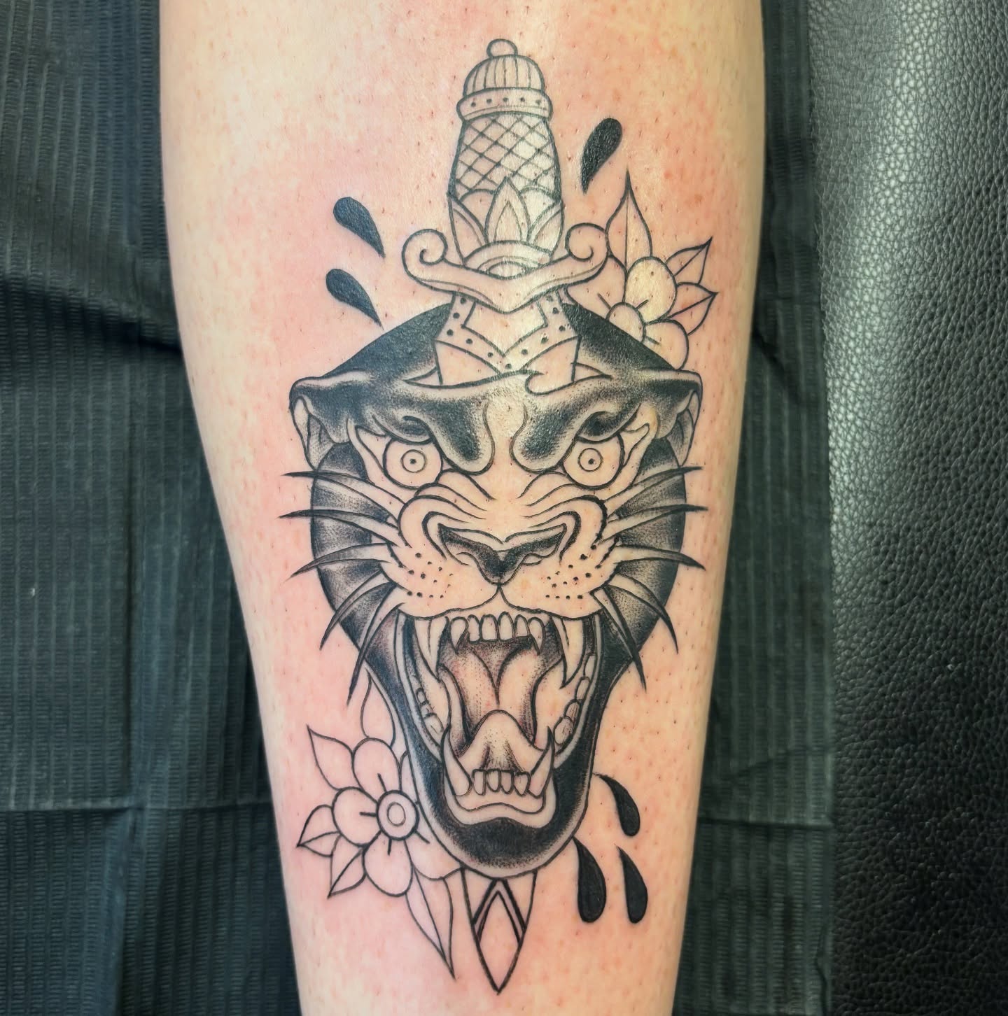 Roaring panther American traditional tattoo on the forearm by Ivanna