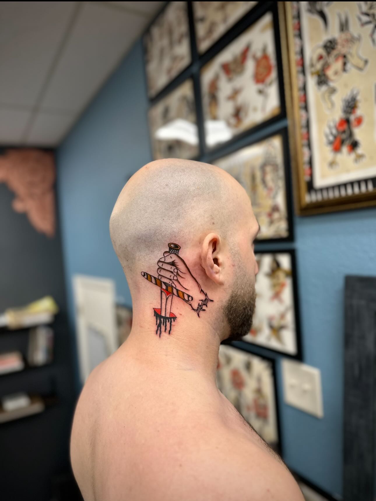 Hand holding scissors American traditional tattoo on the neck by rory