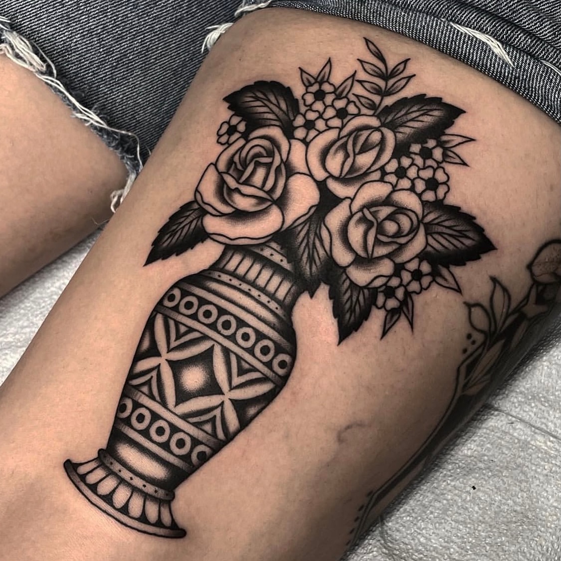 Vase with roses American traditional tattoo on the thigh by Dakota Jenner