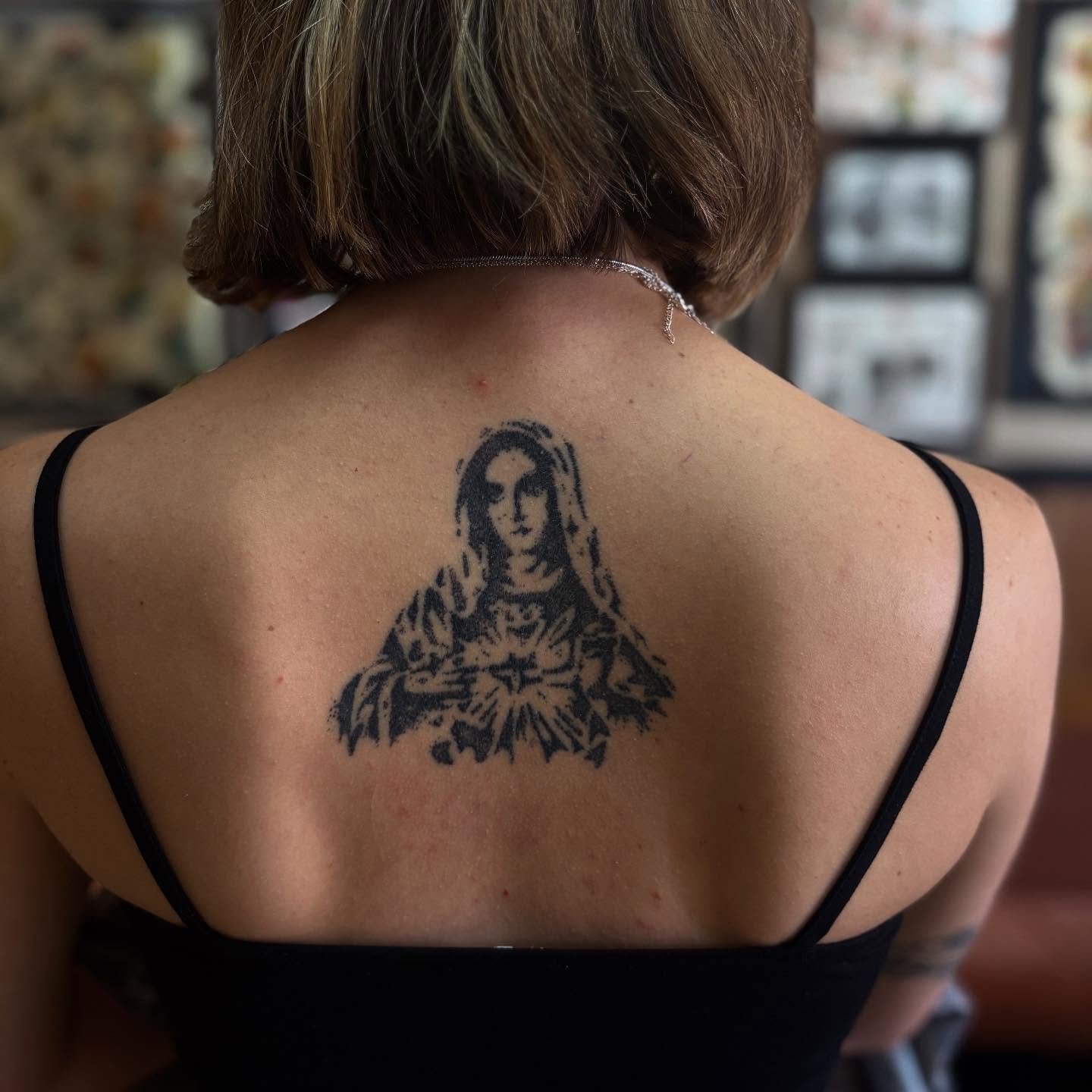 Religious figure black and grey tattoo on the back by Lauren Deets