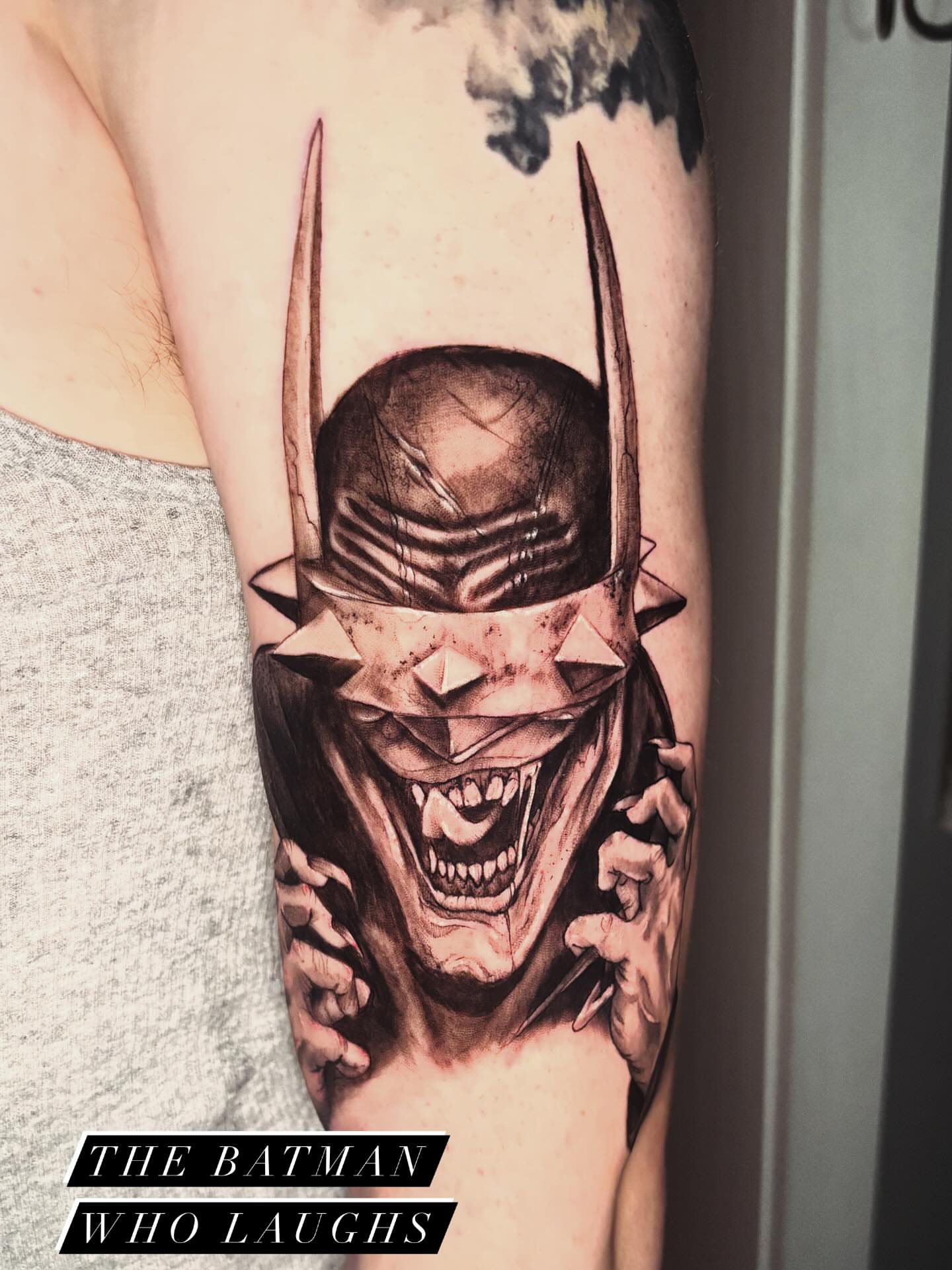 The Batman Who Laughs dark realism tattoo on the forearm by Kayla