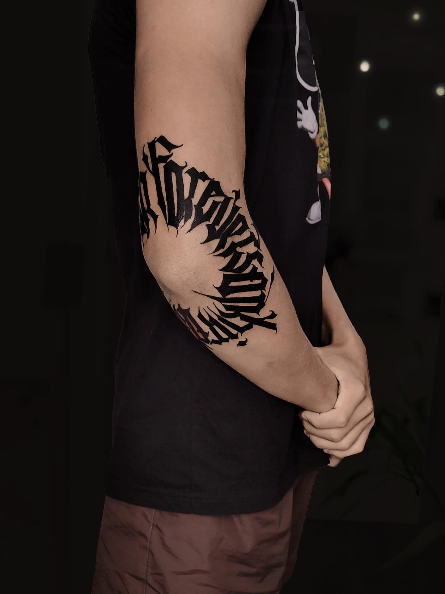 Gothic script lettering script tattoo on the forearm by Артем Летний