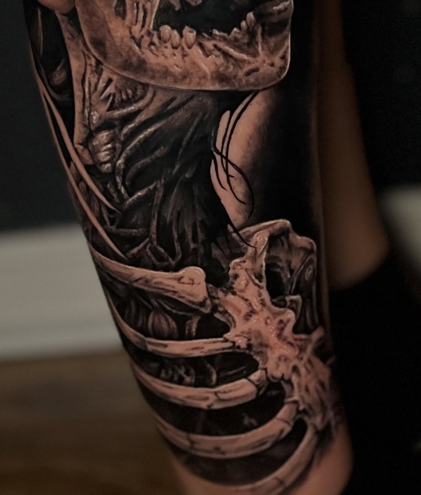 Skull and bones realism tattoo on the forearm by Tucker, Maryville, Tennessee