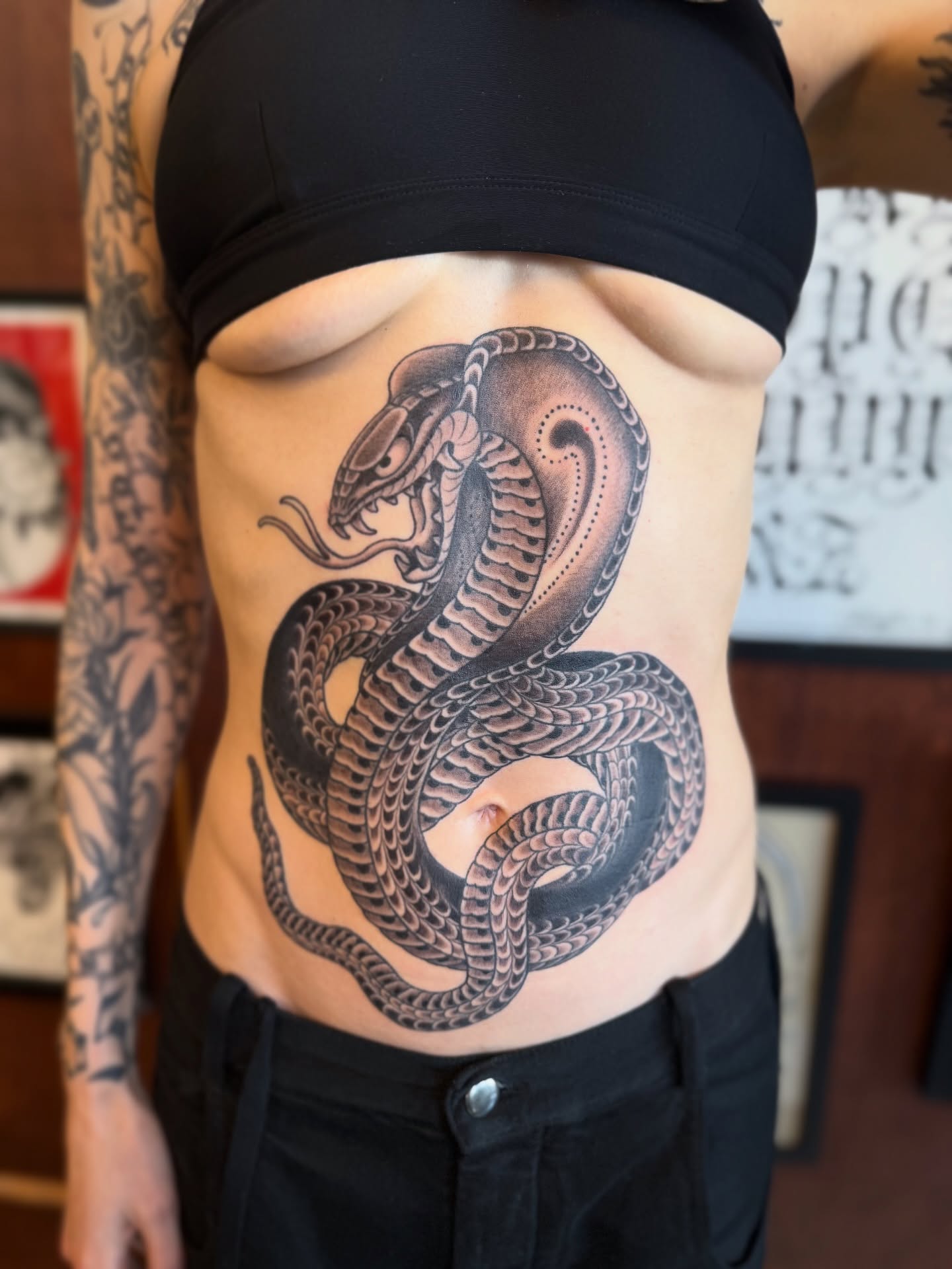 Snake dotwork tattoo on the torso by Candi Kinyōbi