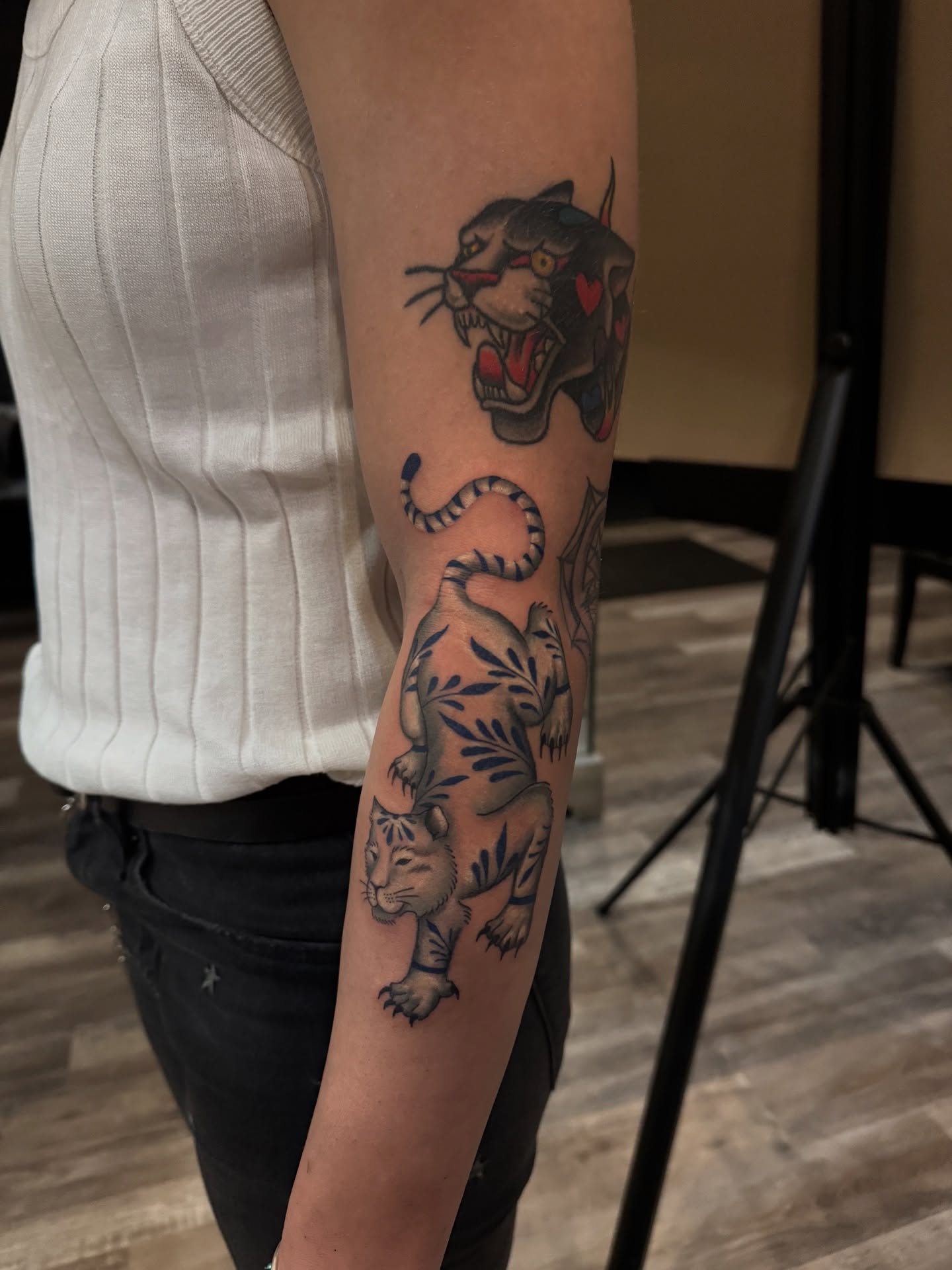 Tiger and panther American traditional tattoo on the forearm by Nathalie Briseno
