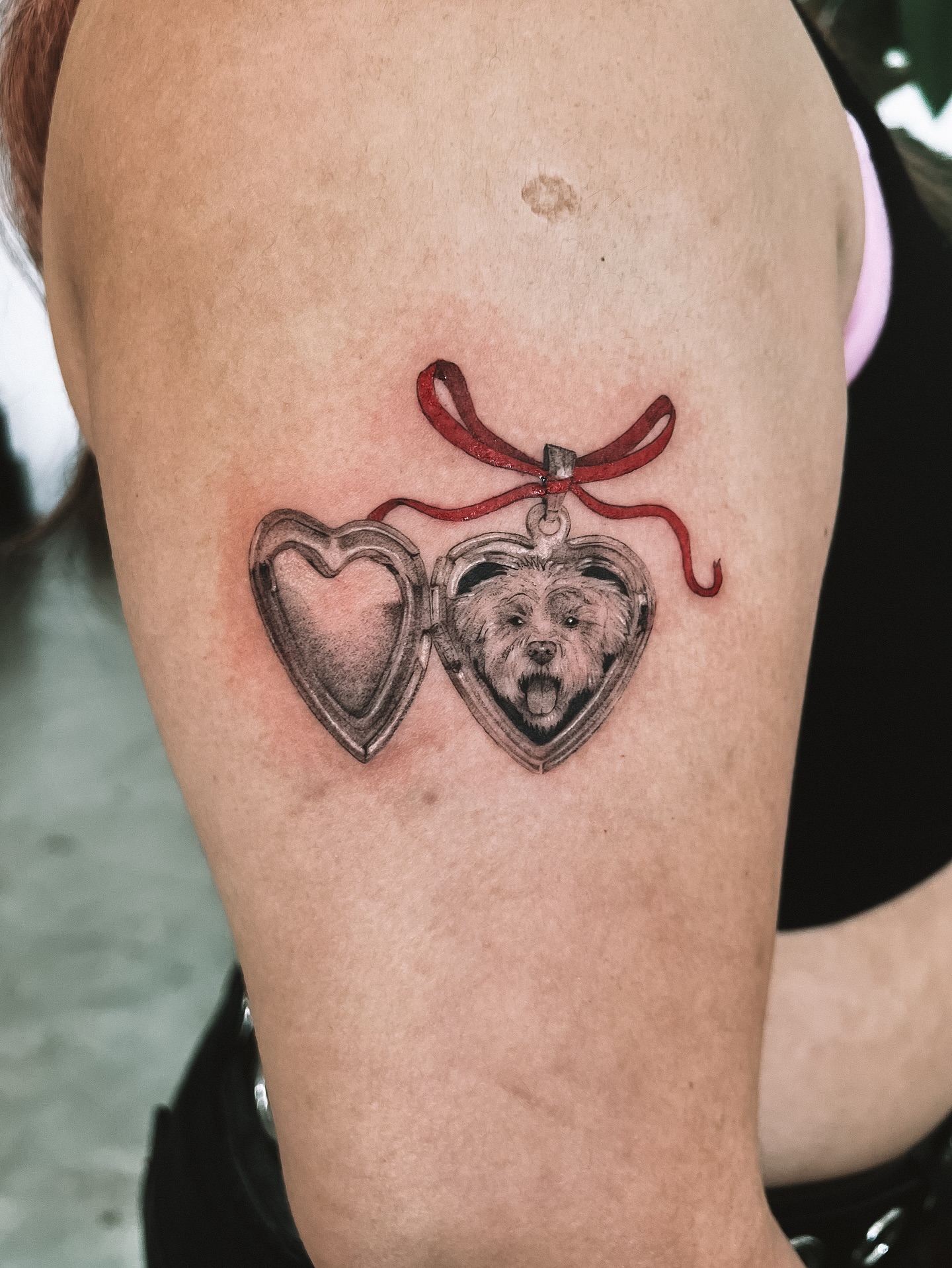 Dog in heart locket realism tattoo on the thigh by sebs phạm, Los Angeles, California