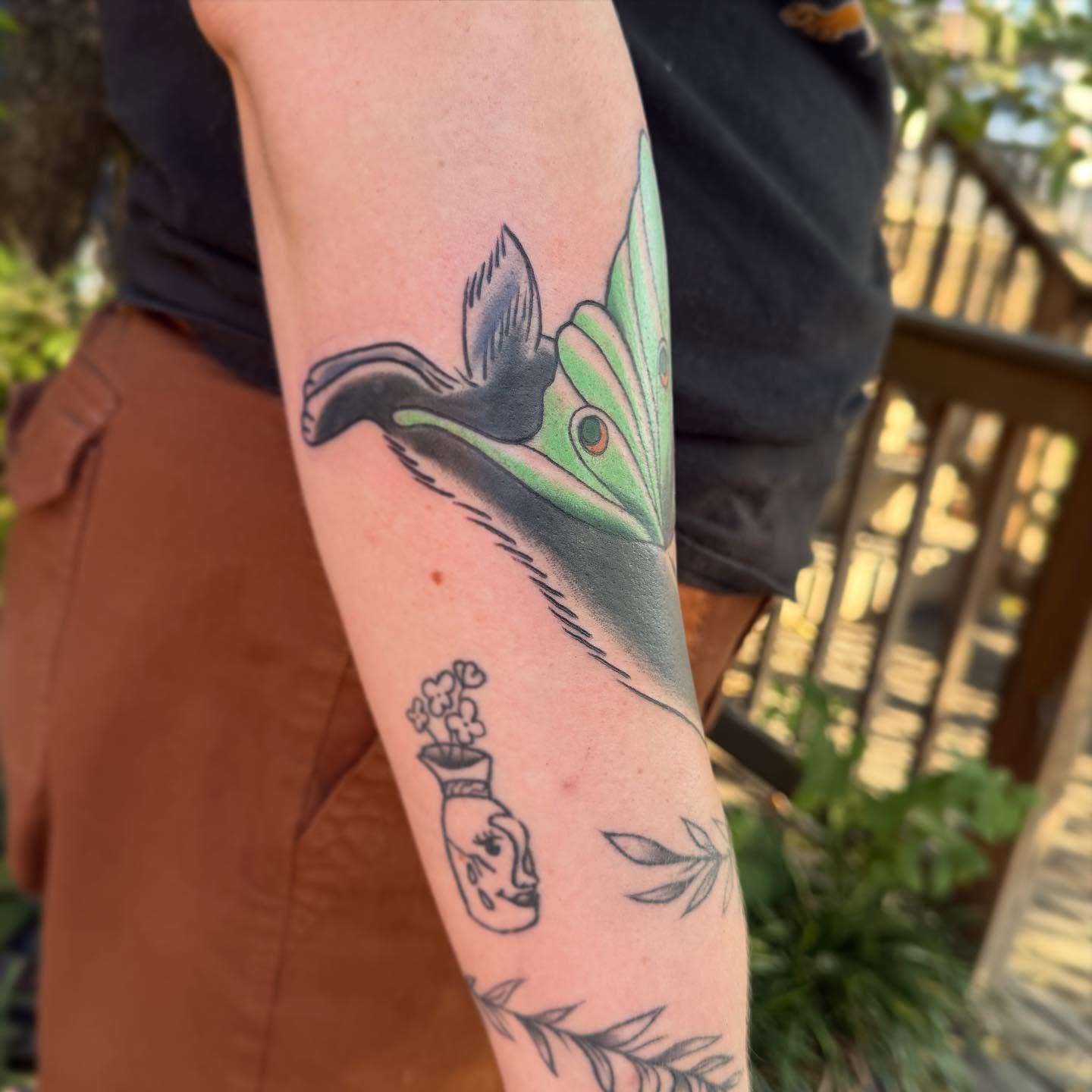 Bird and flower realism tattoo on the forearm by Michelle