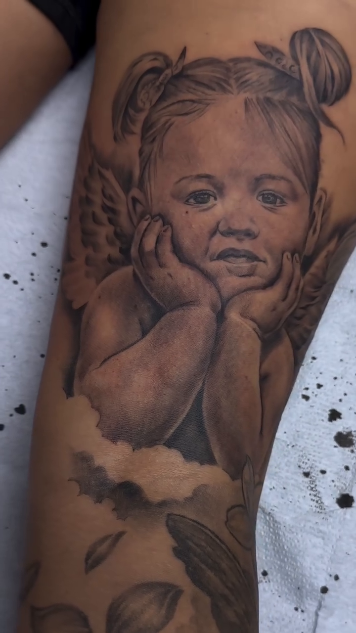 Cherub baby realism tattoo by Matthew Doherty