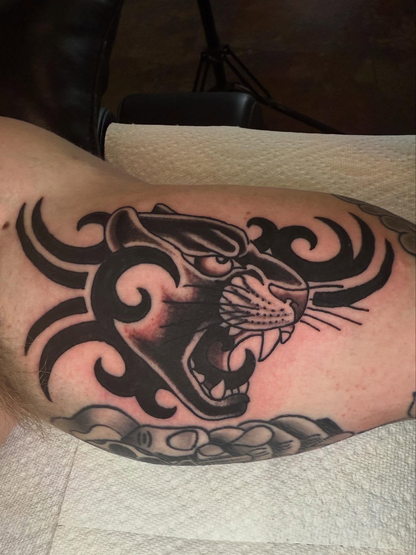 Panther tribal tattoo on the thigh by Seth Walker
