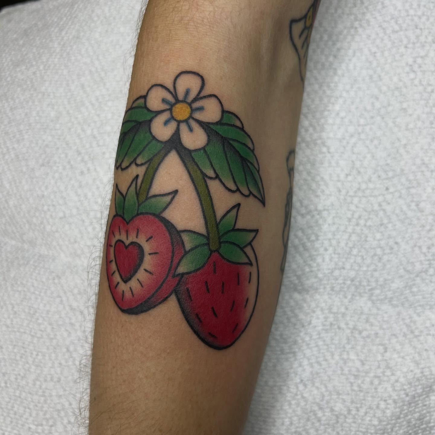 Strawberry and flower American traditional tattoo on the forearm by Bregan ✨