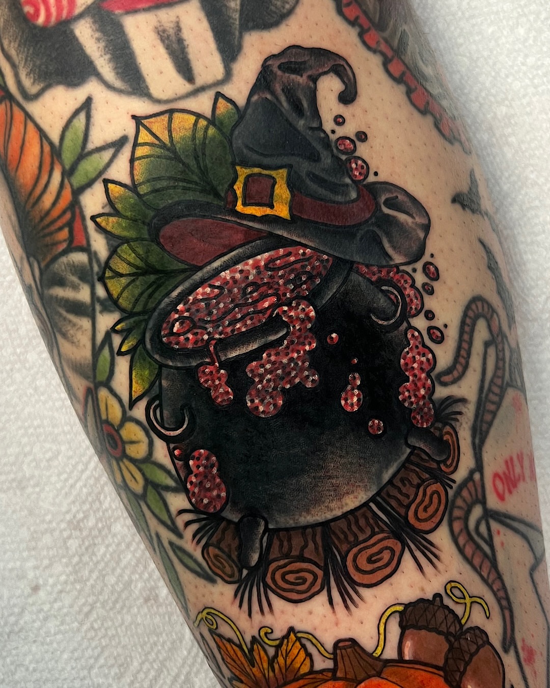 Cauldron with witch hat American traditional tattoo on the forearm by @shannonkeeleyy