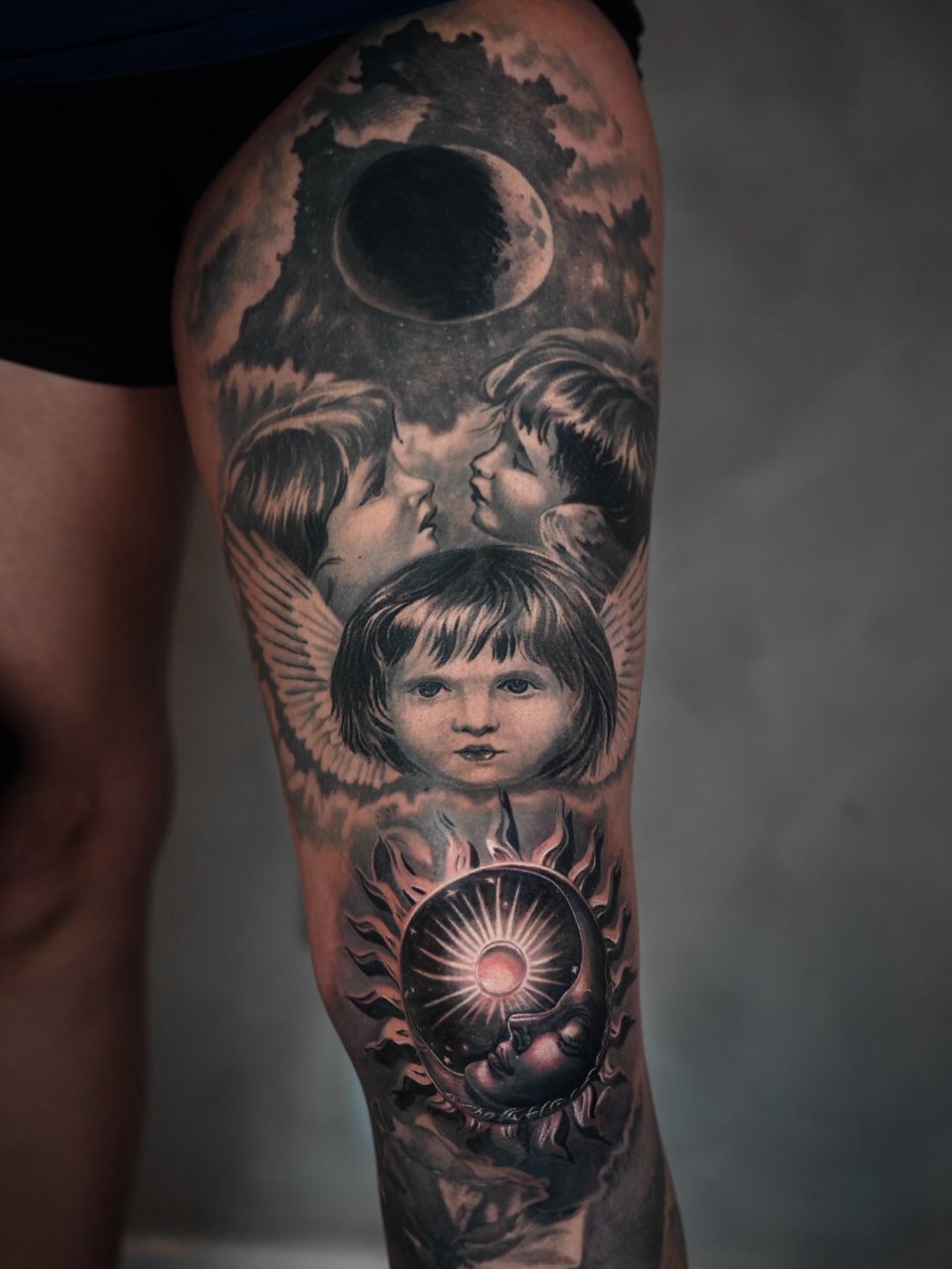 Angels and sun realism tattoo on the thigh by Bailey Lemus