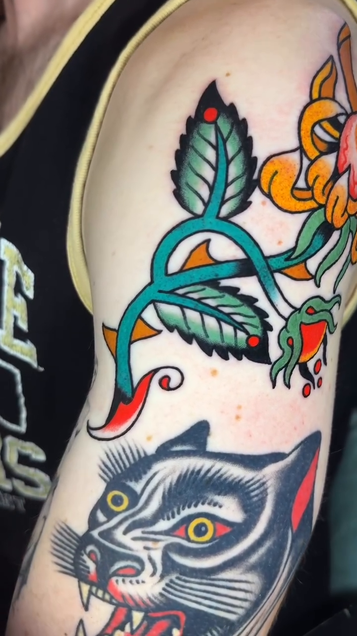 Flower and panther American traditional tattoo by Hayden Combs