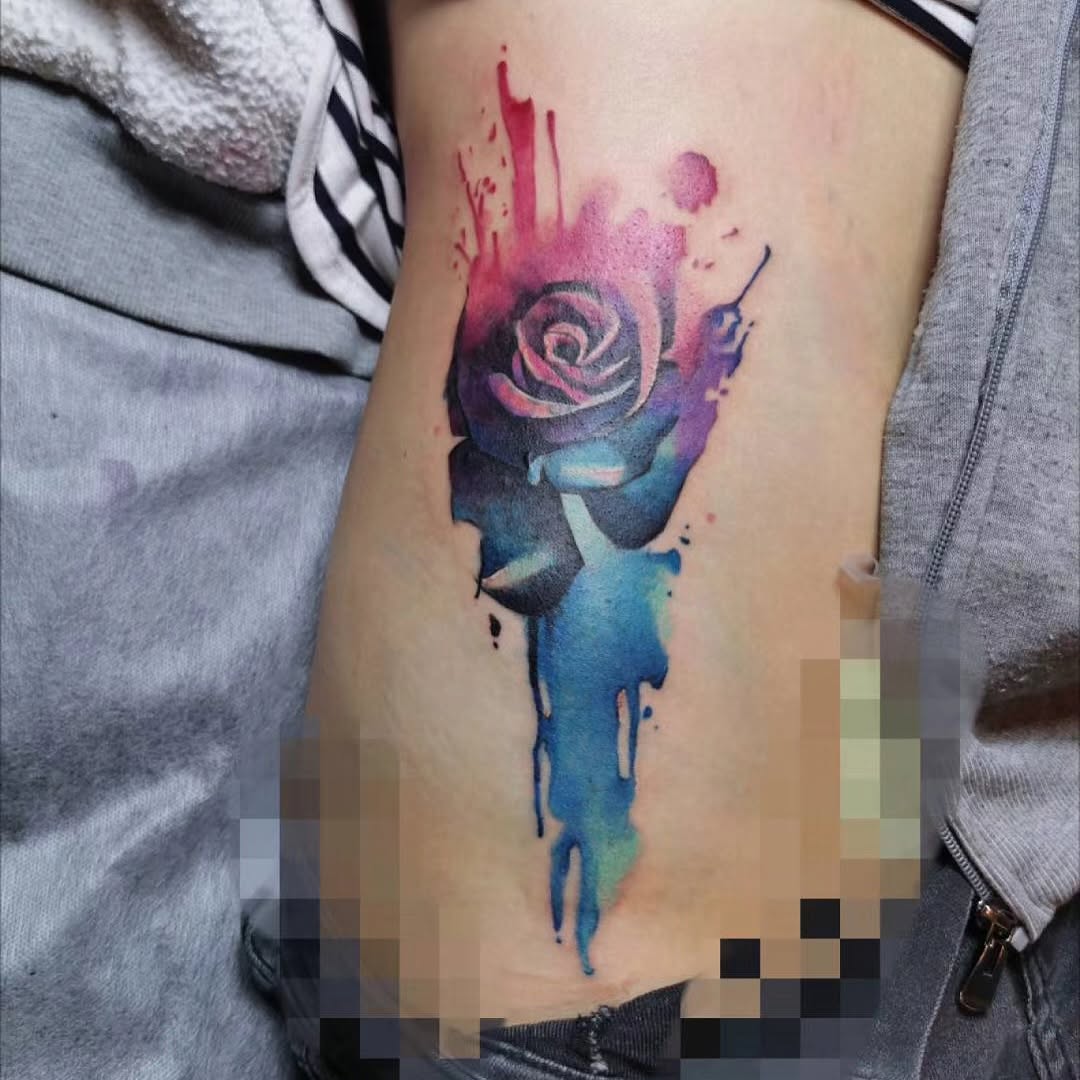Rose with watercolor splashes watercolor tattoo on the thigh by Sydney Walk in Tattoo, Sydney, New South Wales