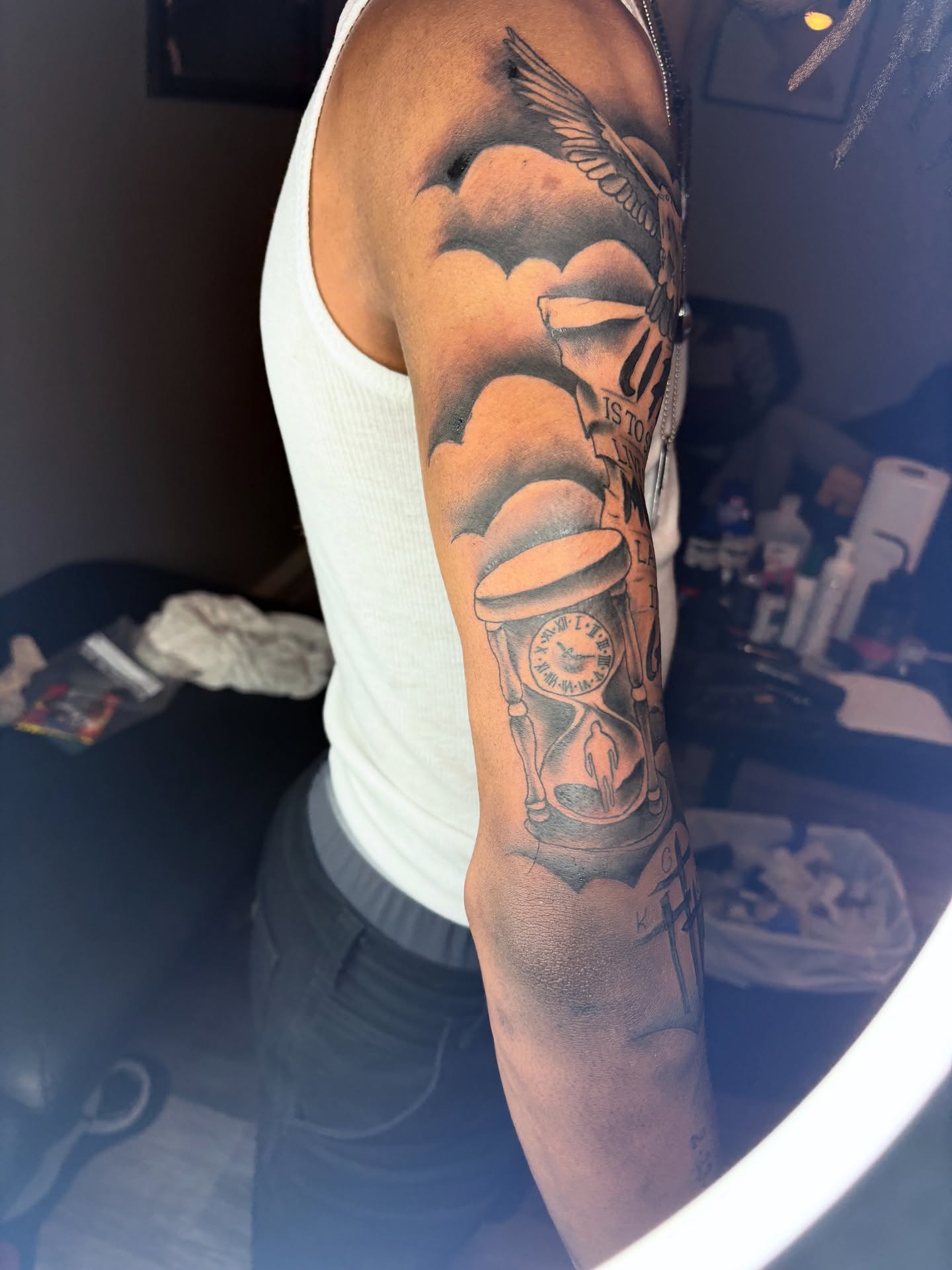 Hourglass and skull black and grey tattoo on the forearm by Maleek Inkz