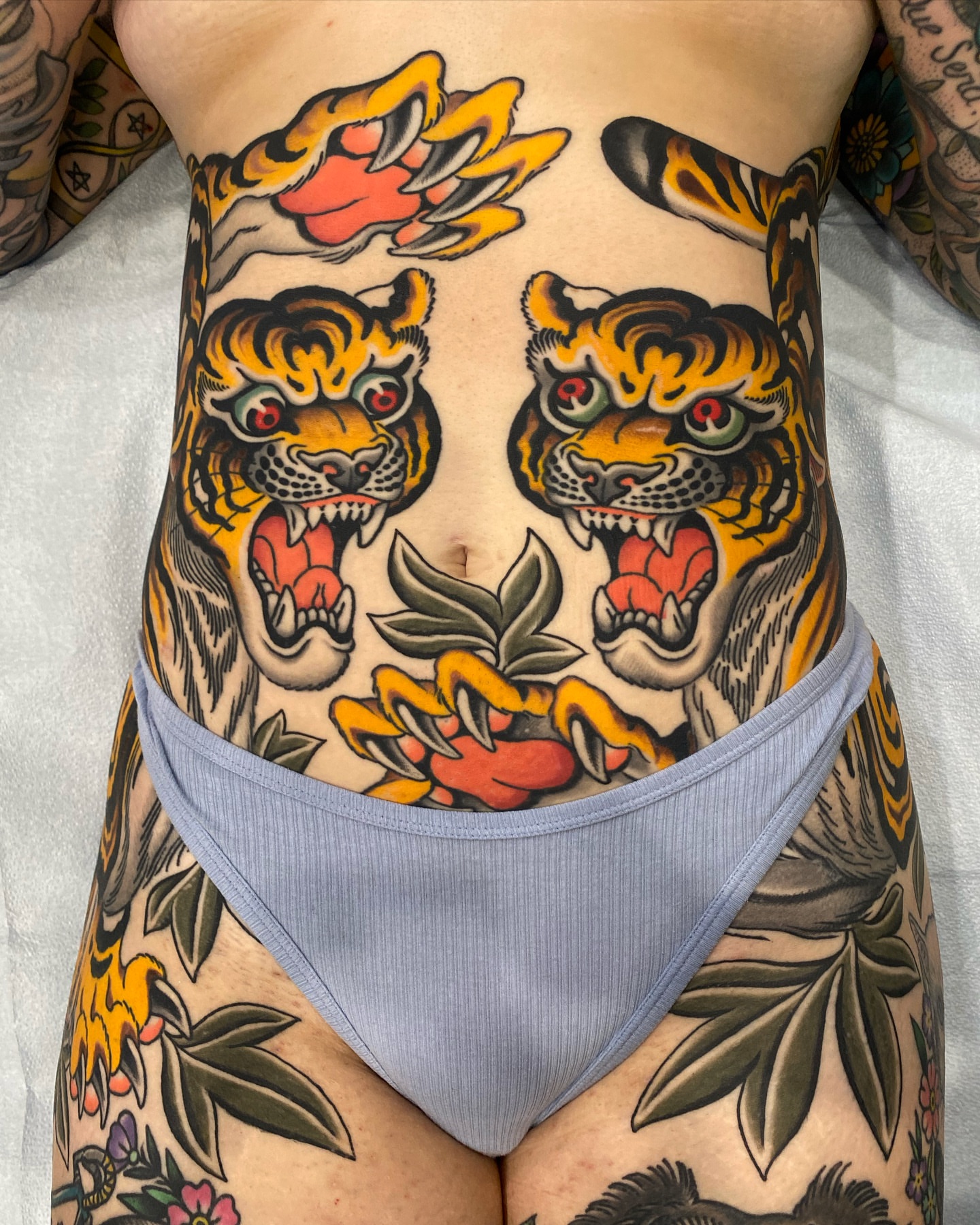 Tiger heads American traditional tattoo on the torso by Wes Hoffman