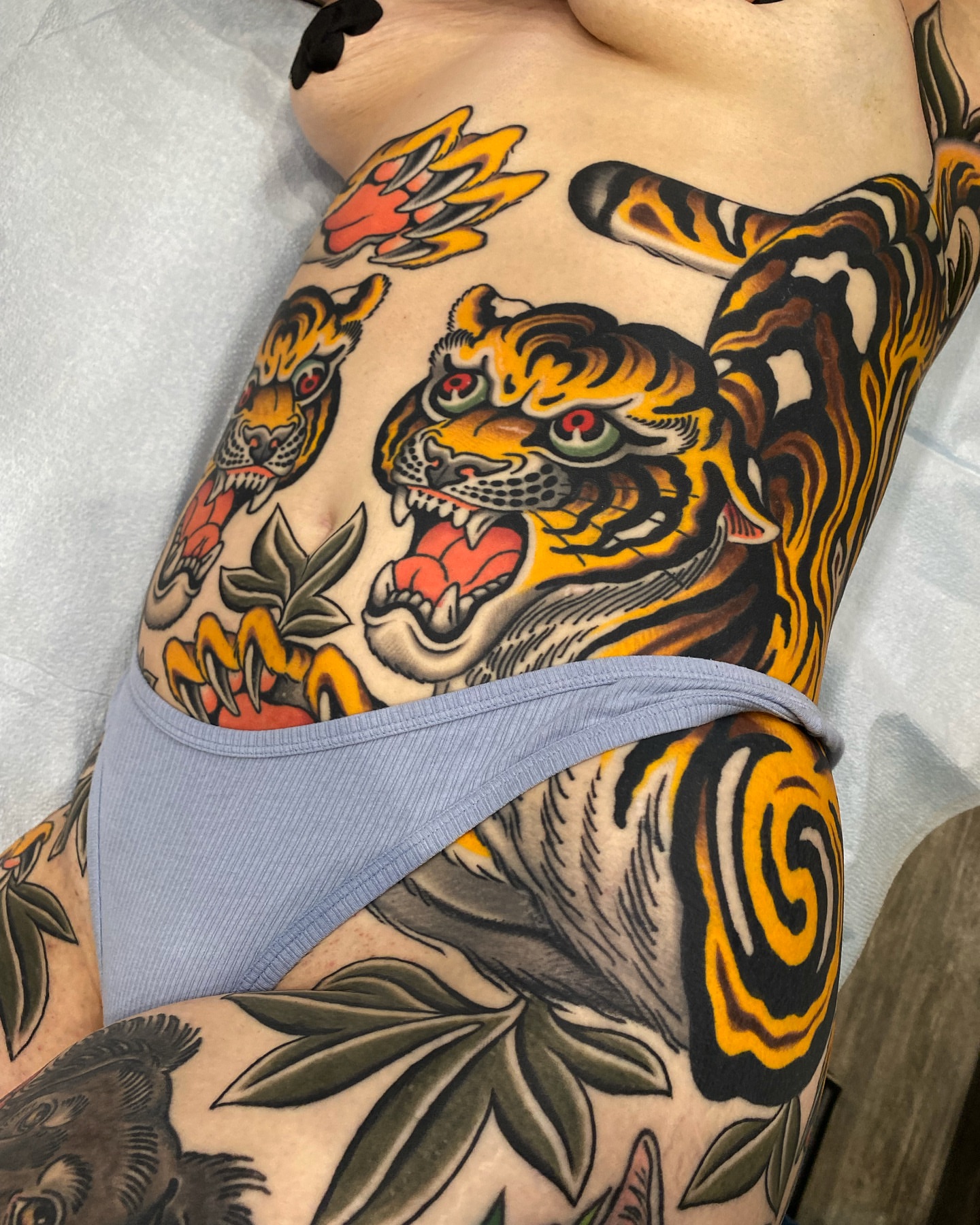 Tiger American traditional tattoo on the thigh by Wes Hoffman