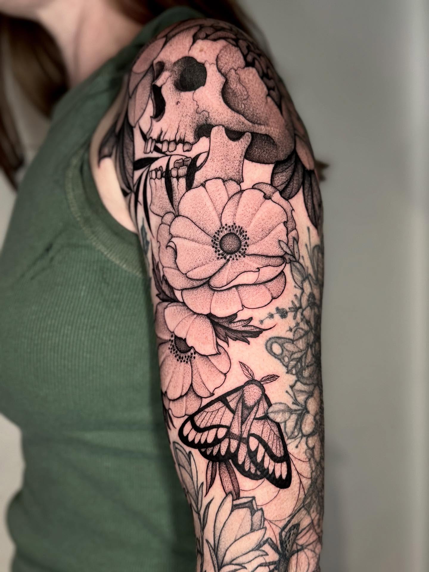 Skull and flowers dotwork tattoo on the forearm by Lauren Llerandi