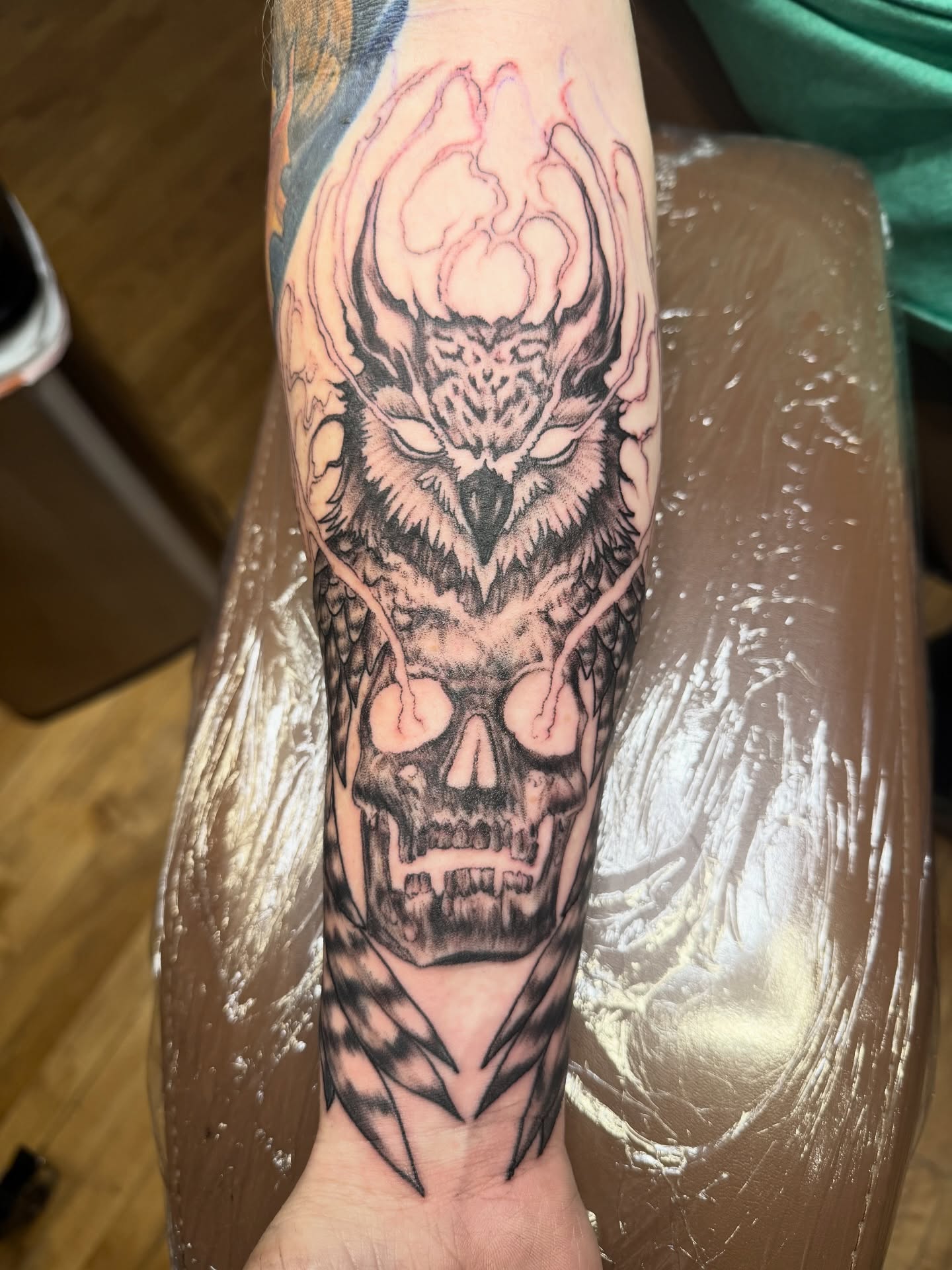 Owl and skull realism tattoo on the forearm by steven