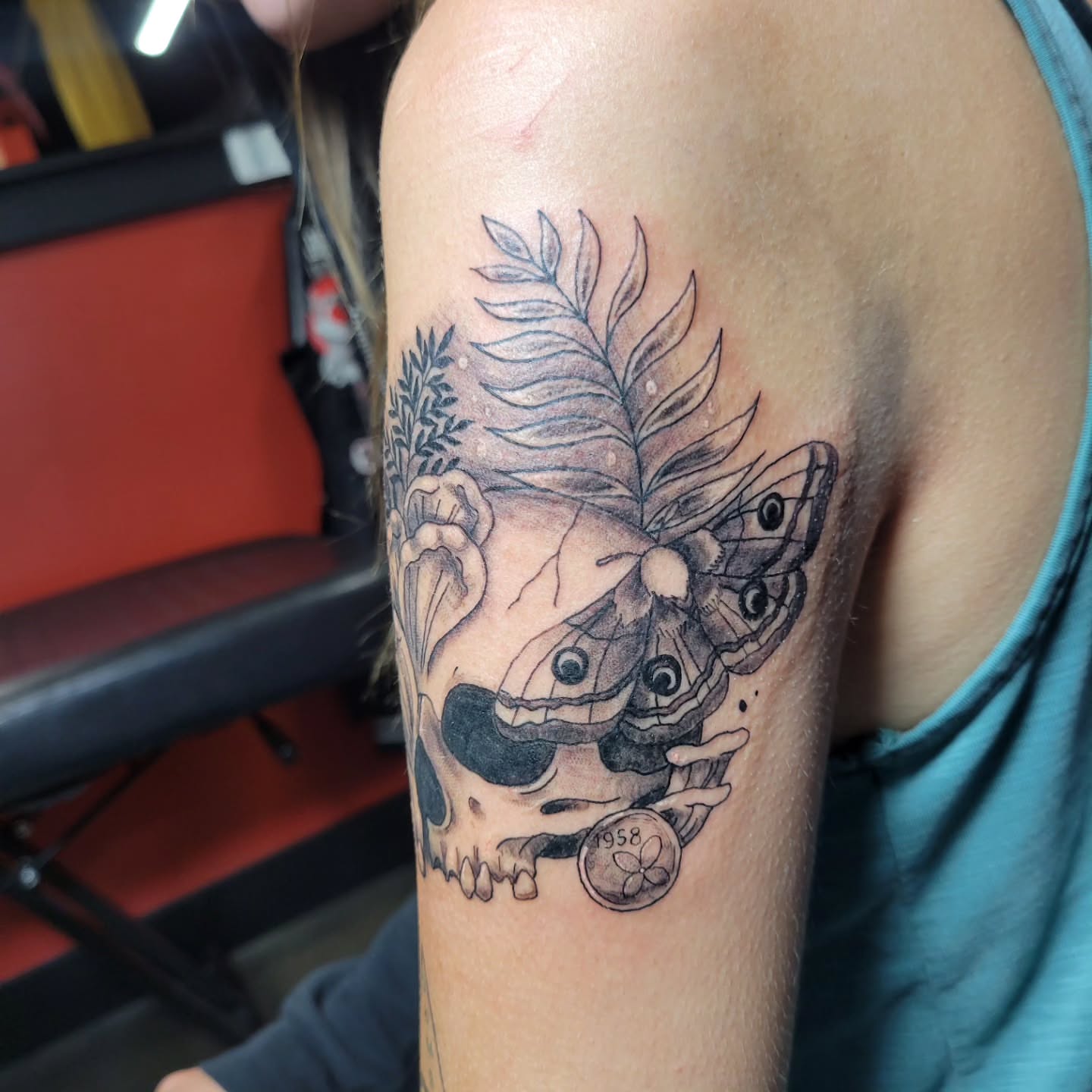 Skull and butterfly realism tattoo on the shoulder by Aspen C