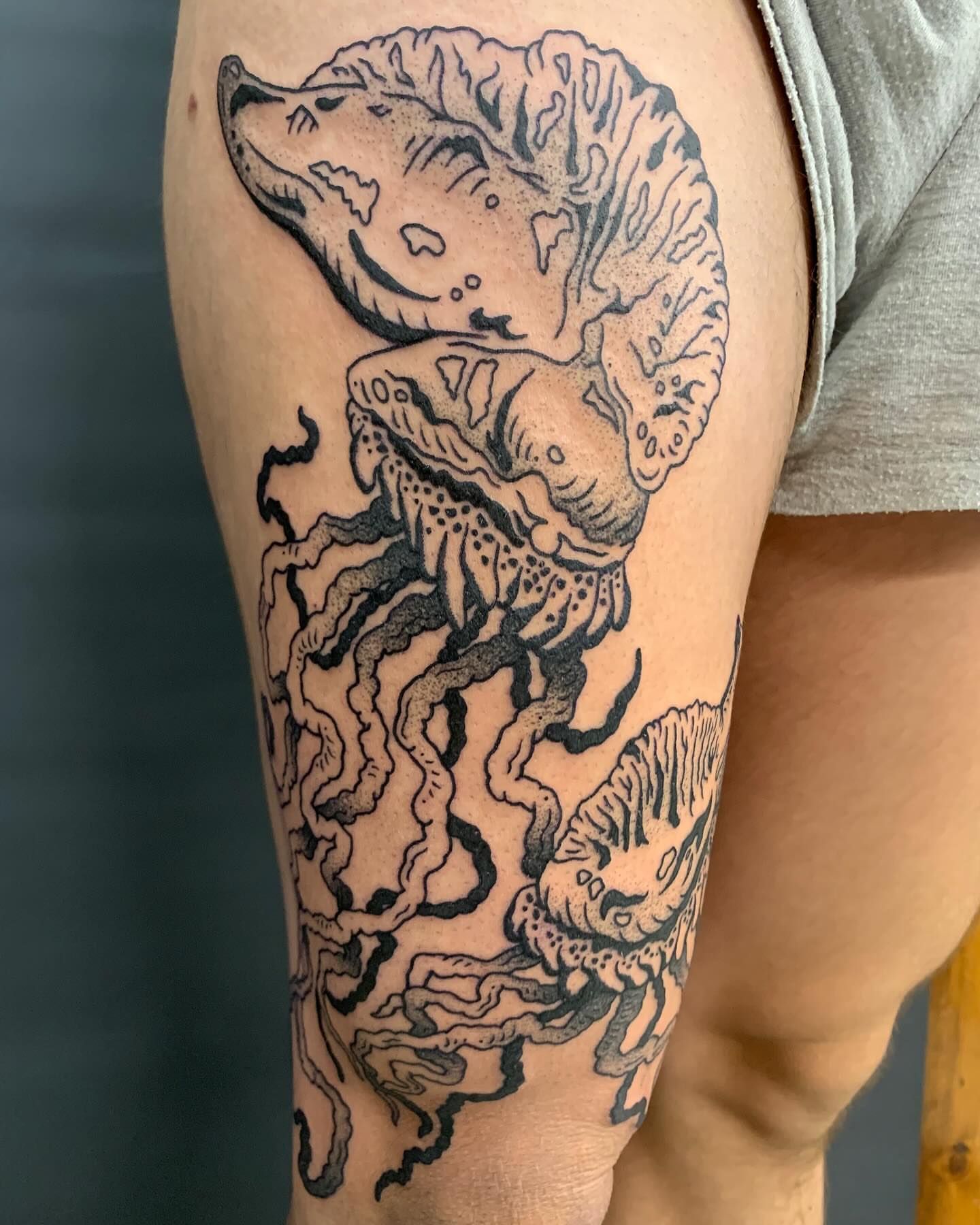 Wolf and jellyfish realism tattoo on the thigh by jay