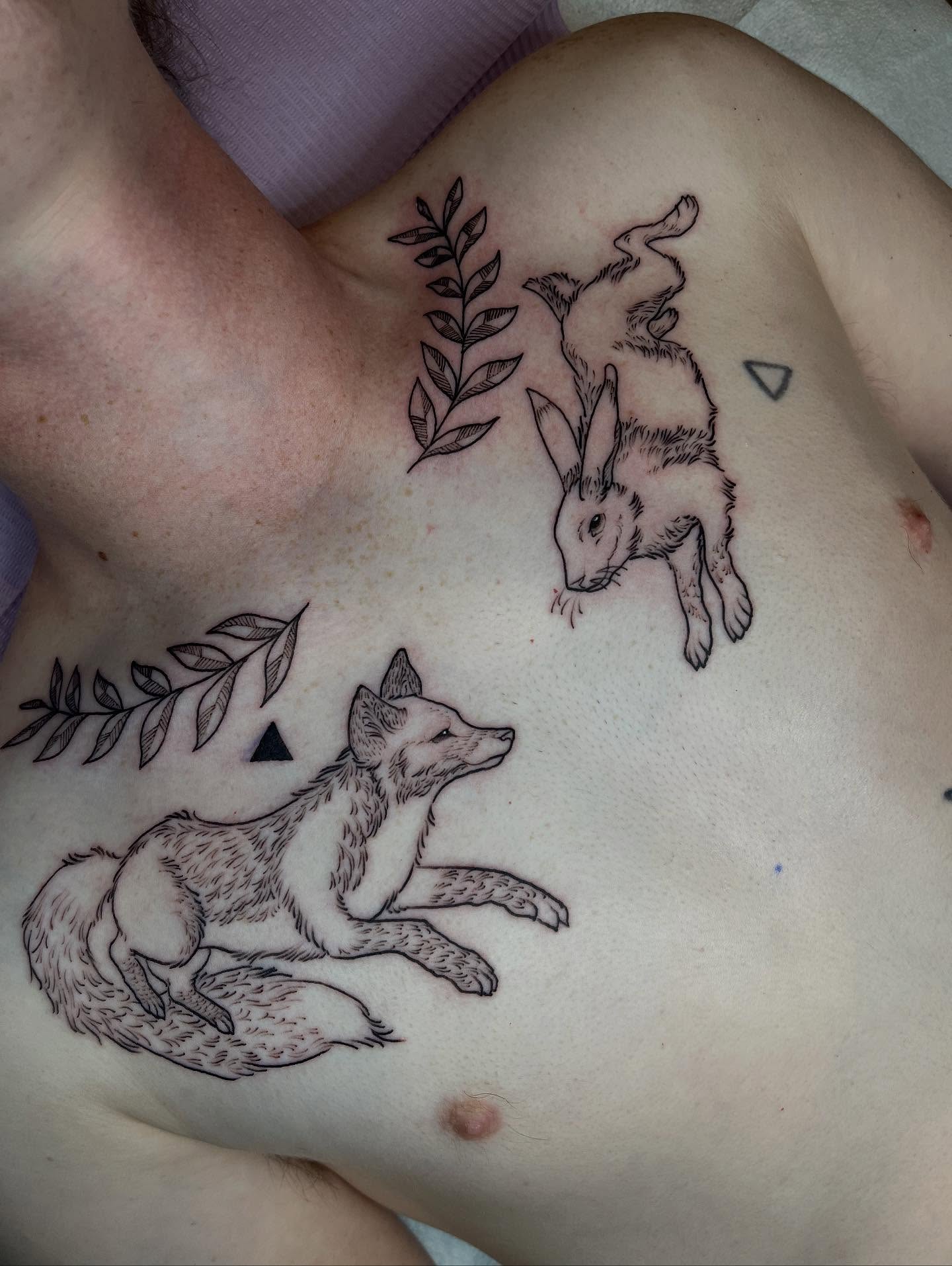 Fox chasing rabbit realism tattoo on the chest by Allison Gallagher