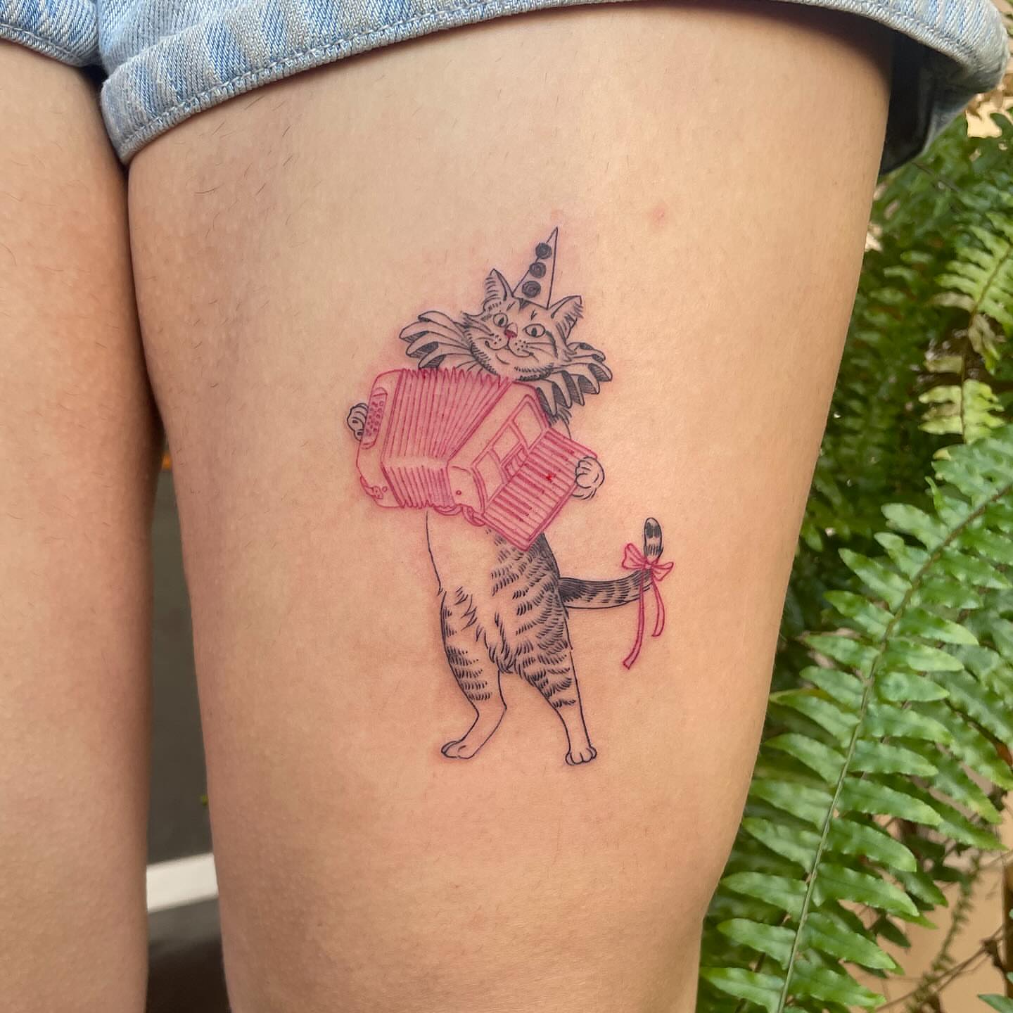 Cat playing accordion dotwork tattoo on the thigh by Ally Easter, Berkeley, California