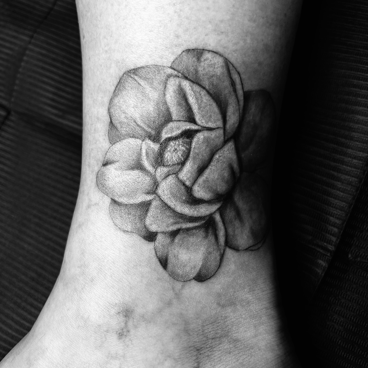 Flower black and grey tattoo on the forearm by Sydney Rose