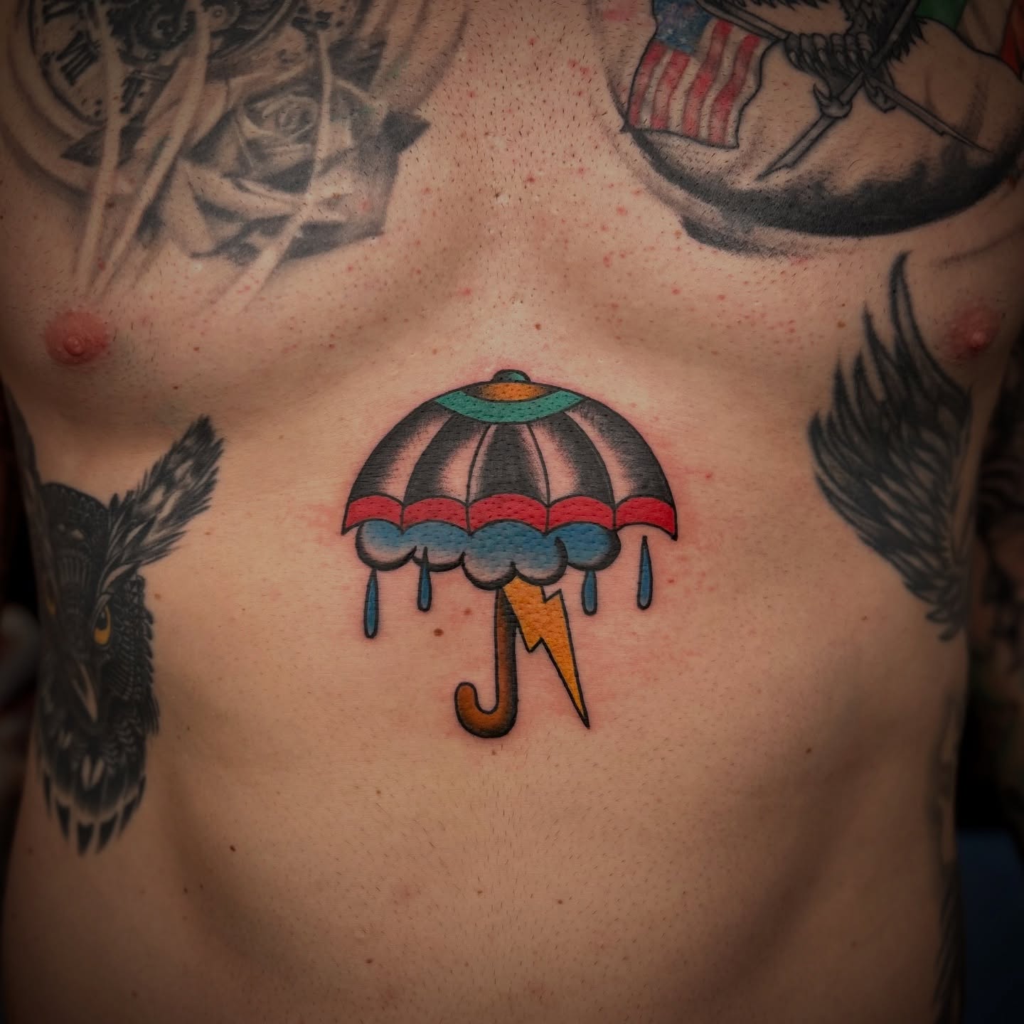 Rainbow umbrella American traditional tattoo on the chest by Bright-bold-classic Tattoos, North Hills