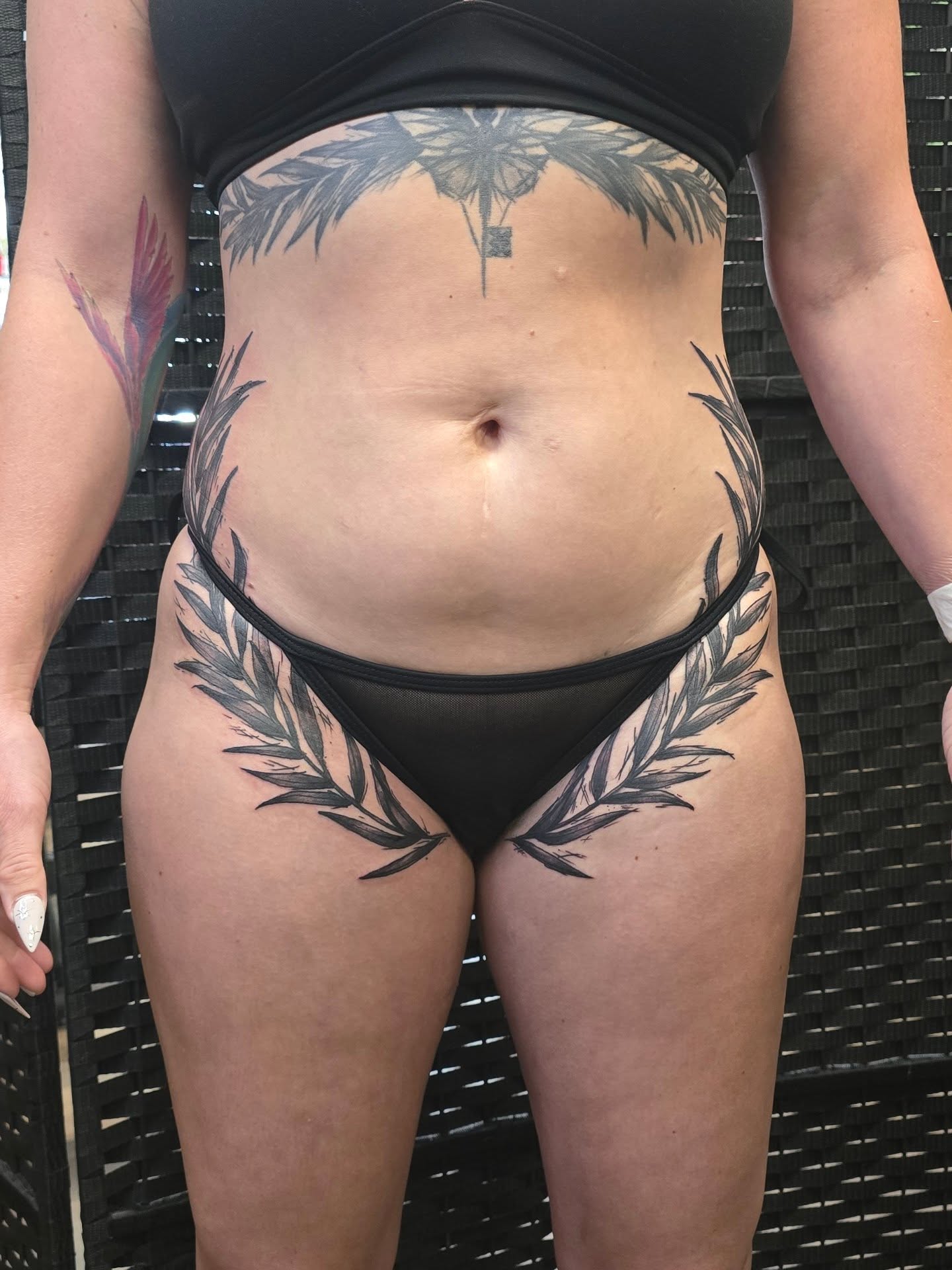 Wreath black and grey tattoo on the torso by Steve Atkinson Tattoo Artist