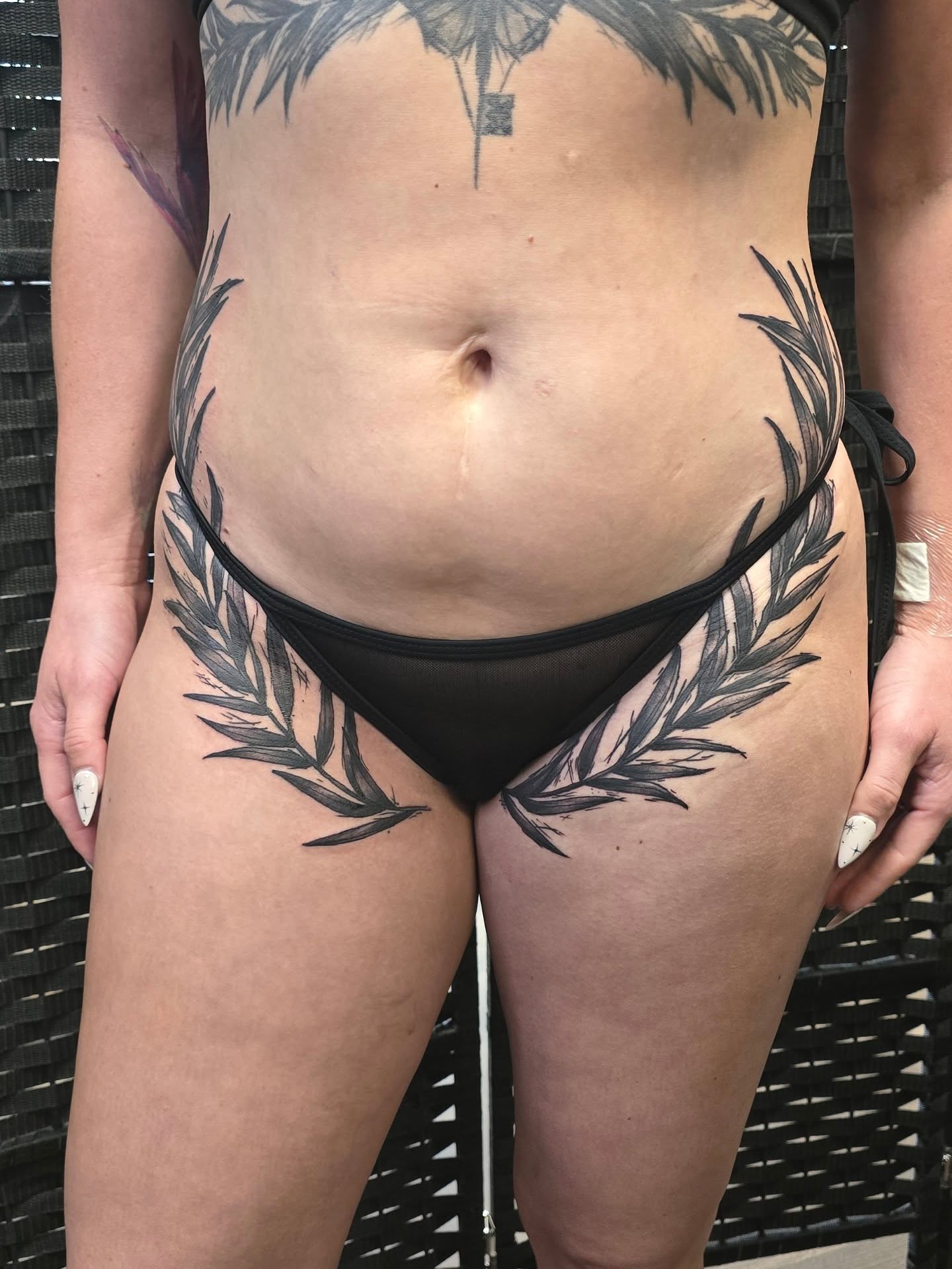 Wreath black and grey tattoo on the thigh by Steve Atkinson Tattoo Artist