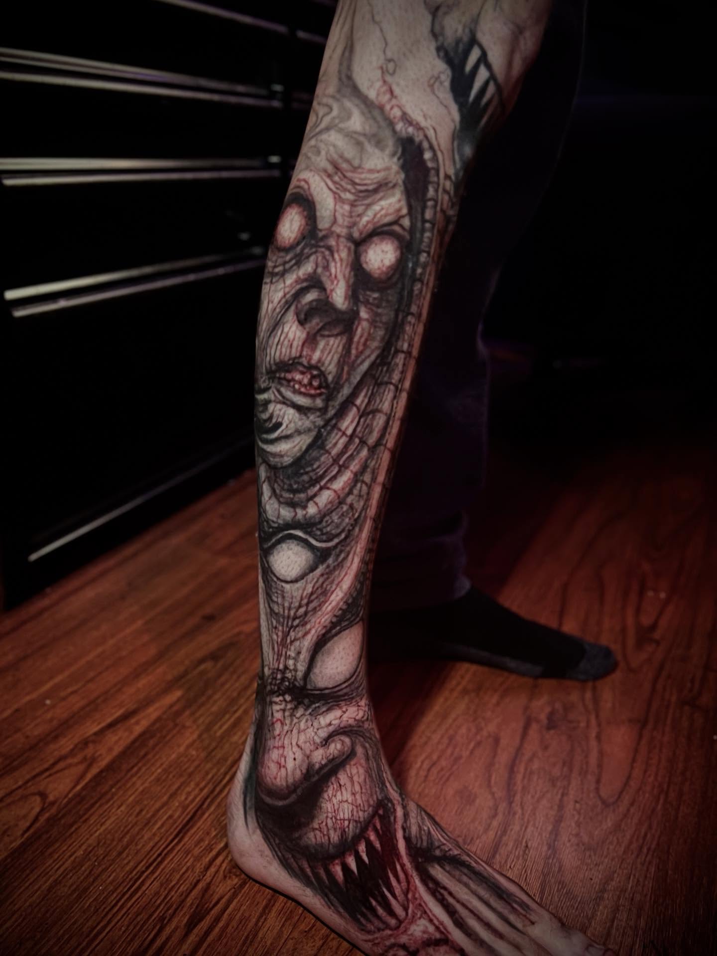 Zombie dark realism tattoo on the calf by Paul Booth