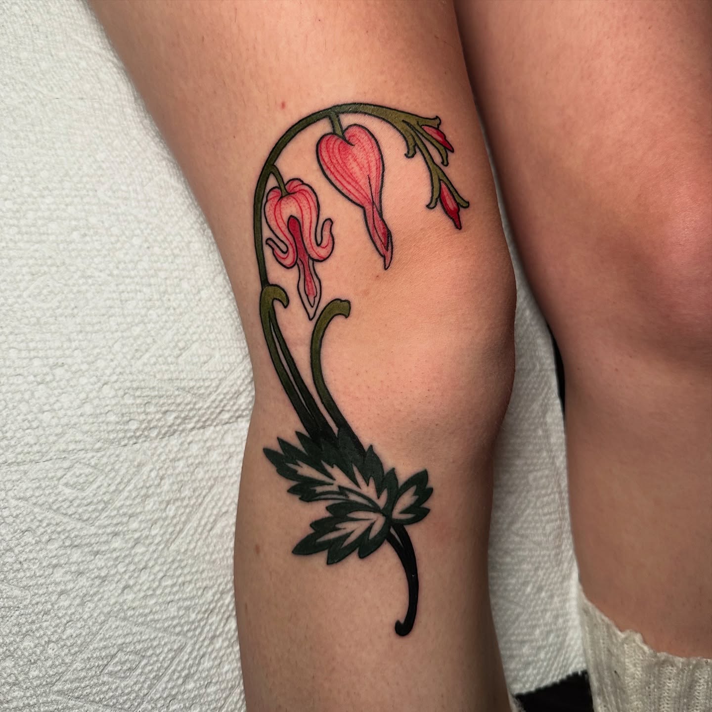 Bleeding heart flowers new school tattoo on the forearm by Tayler Pearson, Fort Collins, Colorado