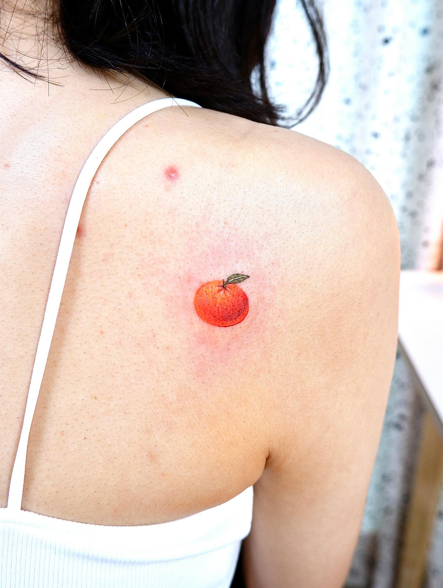 Orange dotwork tattoo on the shoulder by 타투 Seon 컬러타투