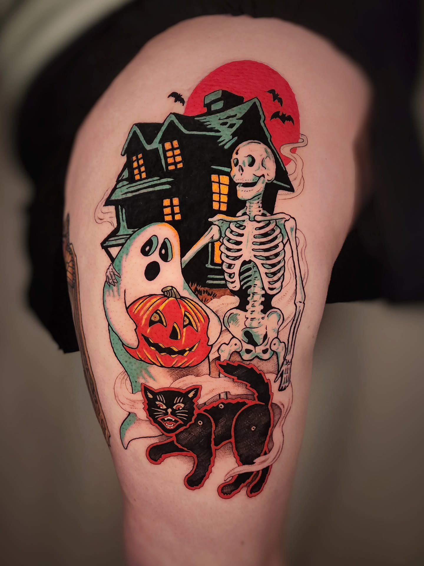 Halloween-themed American traditional tattoo on the thigh by Whitney Caskey