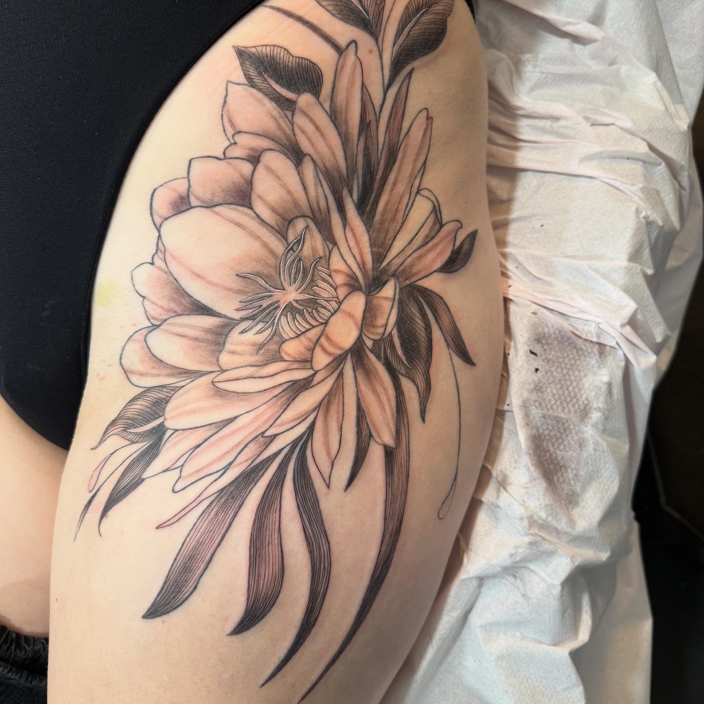 Flower realism tattoo on the upper arm by Brandie Caroline, Somers Point, New Jersey