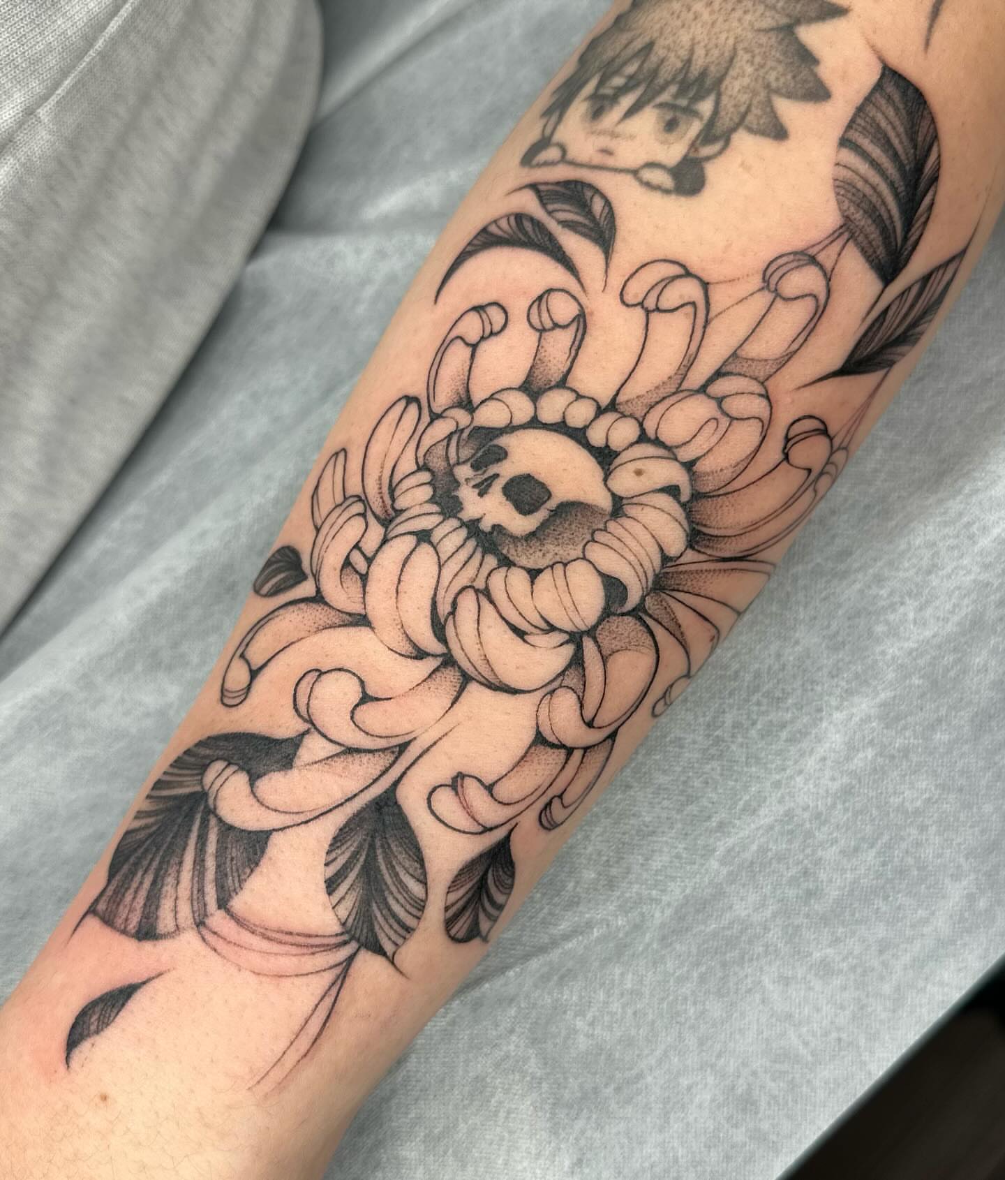 Chrysanthemum dotwork tattoo on the forearm by Maggie Angulo