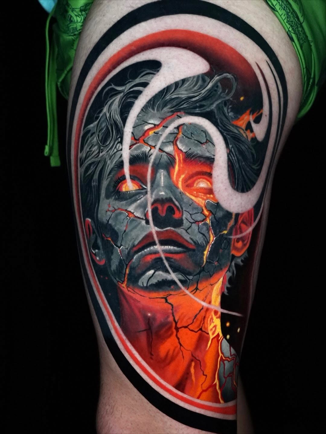 Cracked face with glowing eyes surrealism tattoo on the forearm by Sadier Alfonso