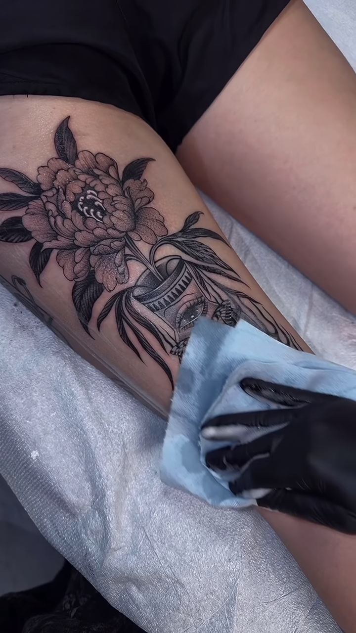 Skull and flowers in a vase realism tattoo by Tattoos.byDahlia, Austin, Texas
