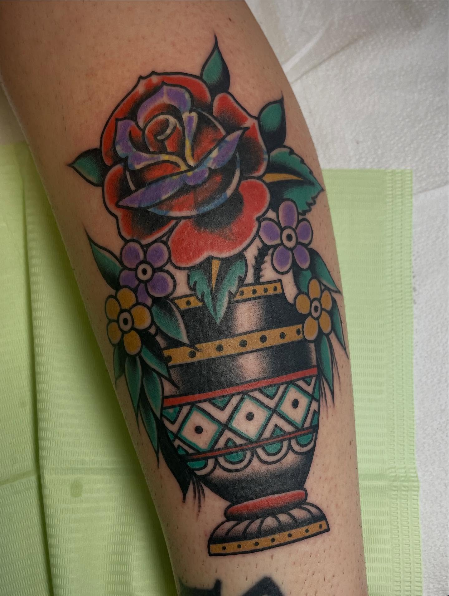 Vase with flowers American traditional tattoo on the forearm by Micheal McGlinchey
