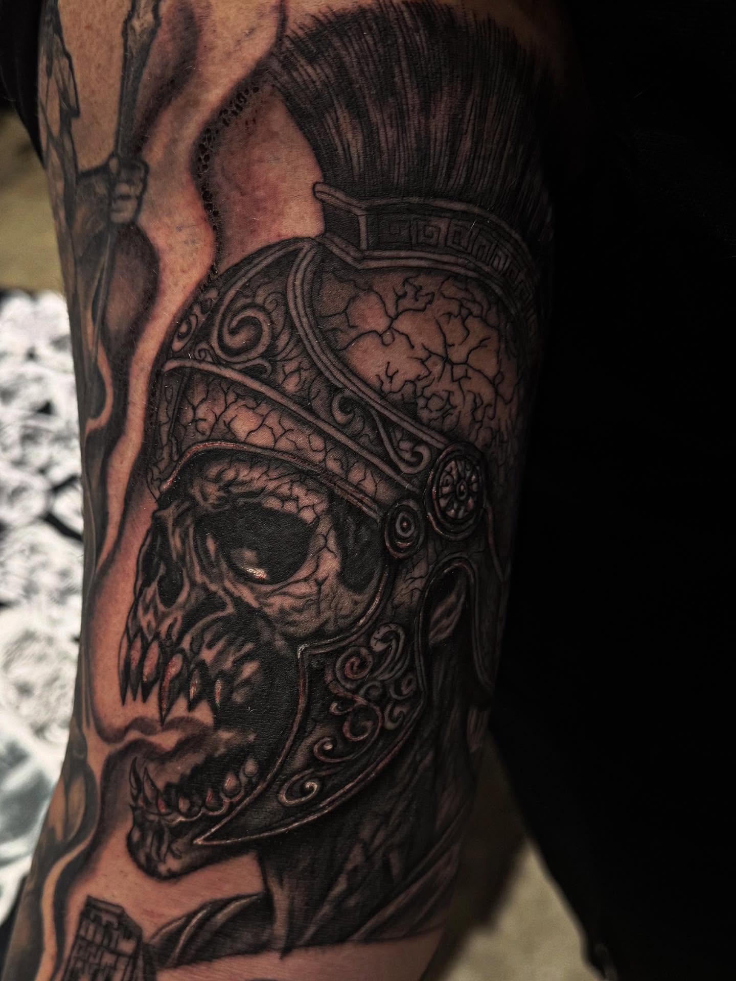 Helmeted skull realism tattoo on the forearm by Therapy ink